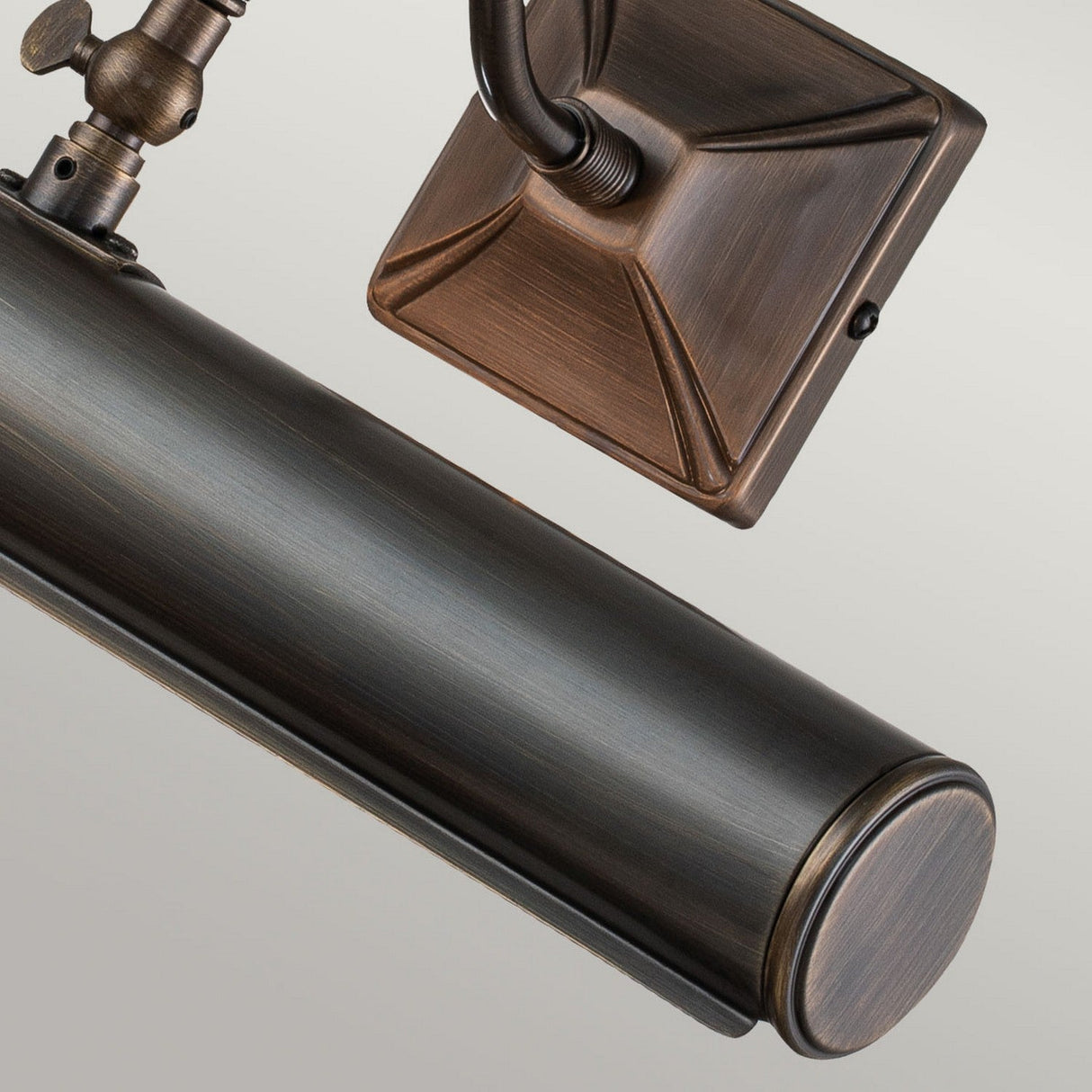 Close-up of the Picture Light 2 Light Large - Dark Bronze. This vintage-style wall-mounted fixture features a cylindrical shape with a rectangular backplate and adjustable lights, ideal for highlighting artwork or photos. The dark bronze finish gives it a classic, antique look.