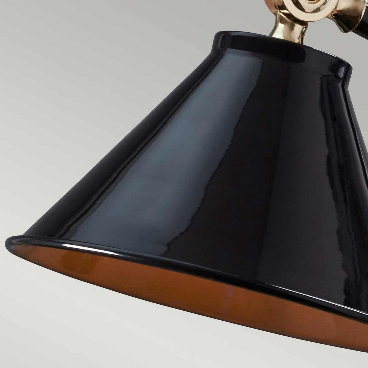 A close-up of a black, cone-shaped lampshade with a glossy finish is attached to a polished brass fixture, echoing a French-inspired design against a neutral background. This perfectly captures the essence of the Provence Element 1 Light Mini Table Lamp - Black/Polished Brass.