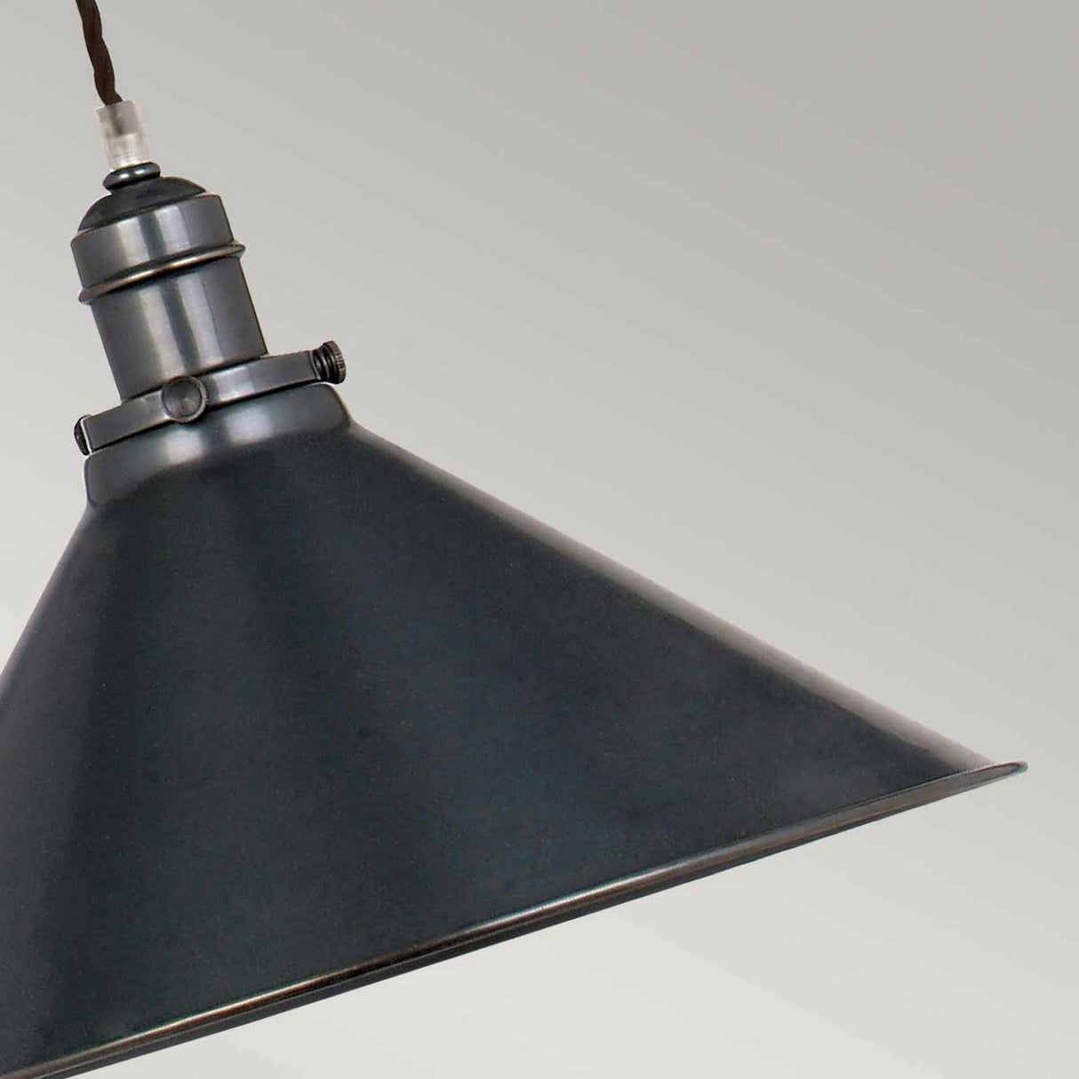 A close-up of the Provence 1 Light Rise & Fall Pendant in an old bronze finish, showcasing its vintage-style black metal construction with a conical shade, hanging against a plain light gray background. This fixture, inspired by French design, highlights visible bolt details at the connection between the shade and its hanging mechanism.