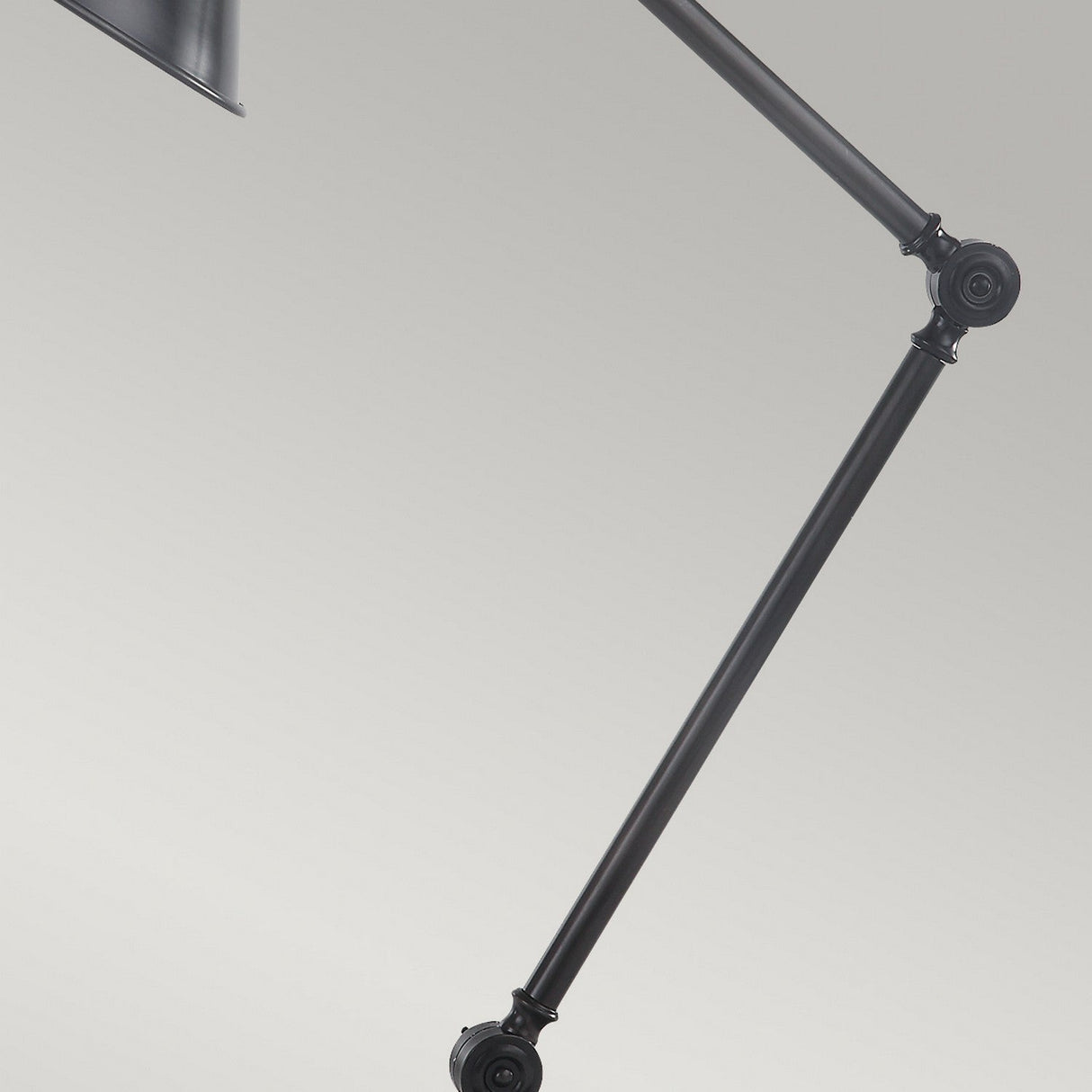 A close-up of the Provence 1 Light Table Lamp in old bronze, featuring sleek adjustable knuckle joints against a light gray background. The image highlights its metal arm and joints, showcasing a stylish design with functional hinges reminiscent of an elegant finish.