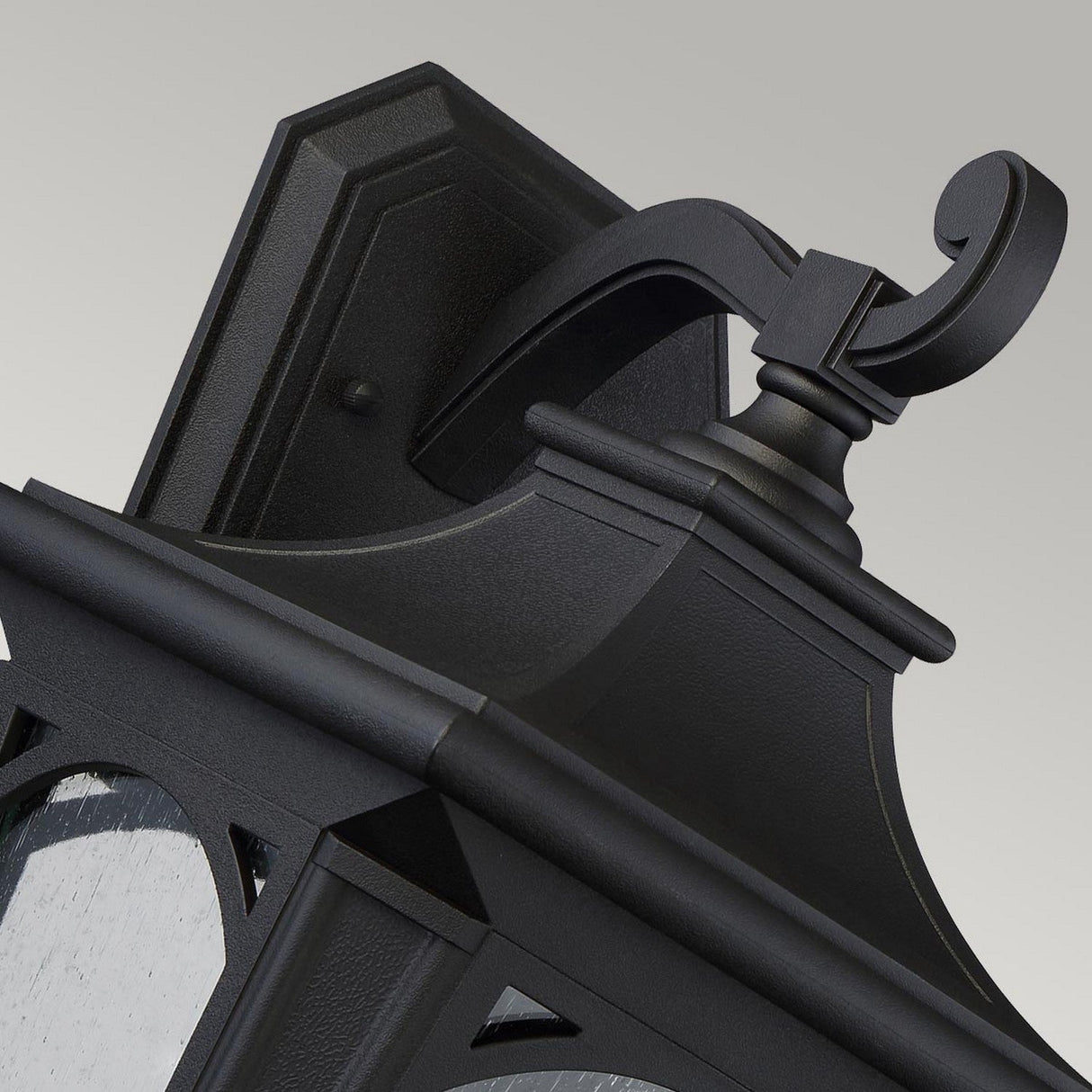 The Bedford Outdoor 1 Light Large Wall Lantern features a black metal finish with decorative scrollwork and a rectangular backplate. Its intricate detailing beautifully complements the frosted glass pane, all set against a neutral gray background.