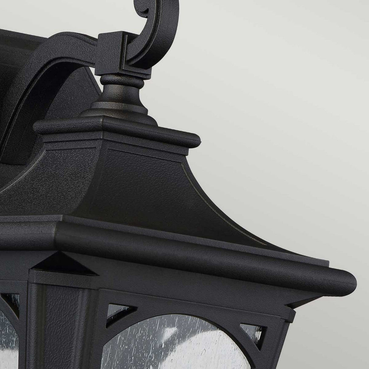 Here's a detailed view of the Bedford Outdoor 1 Light Medium Wall Lantern in black, showcasing its classic design with a curved top and clear seedy glass panels, all set against a light gray background.