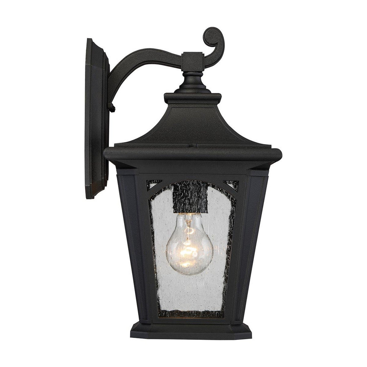 The Bedford Outdoor 1 Light Medium Wall Lantern - Black, mounted on a wall, boasts a classic design. It features clear seedy glass that encases a visible light bulb, providing both an elegant and traditional appearance while delivering durable outdoor lighting.