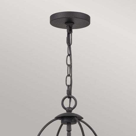 The Bradbury 4 Light Chandelier in Grey Ash showcases a black metal pendant light fixture with a round ceiling mount, linked chain, and curved supports. This versatile design embraces modern aesthetics and hangs elegantly against a light gray background.