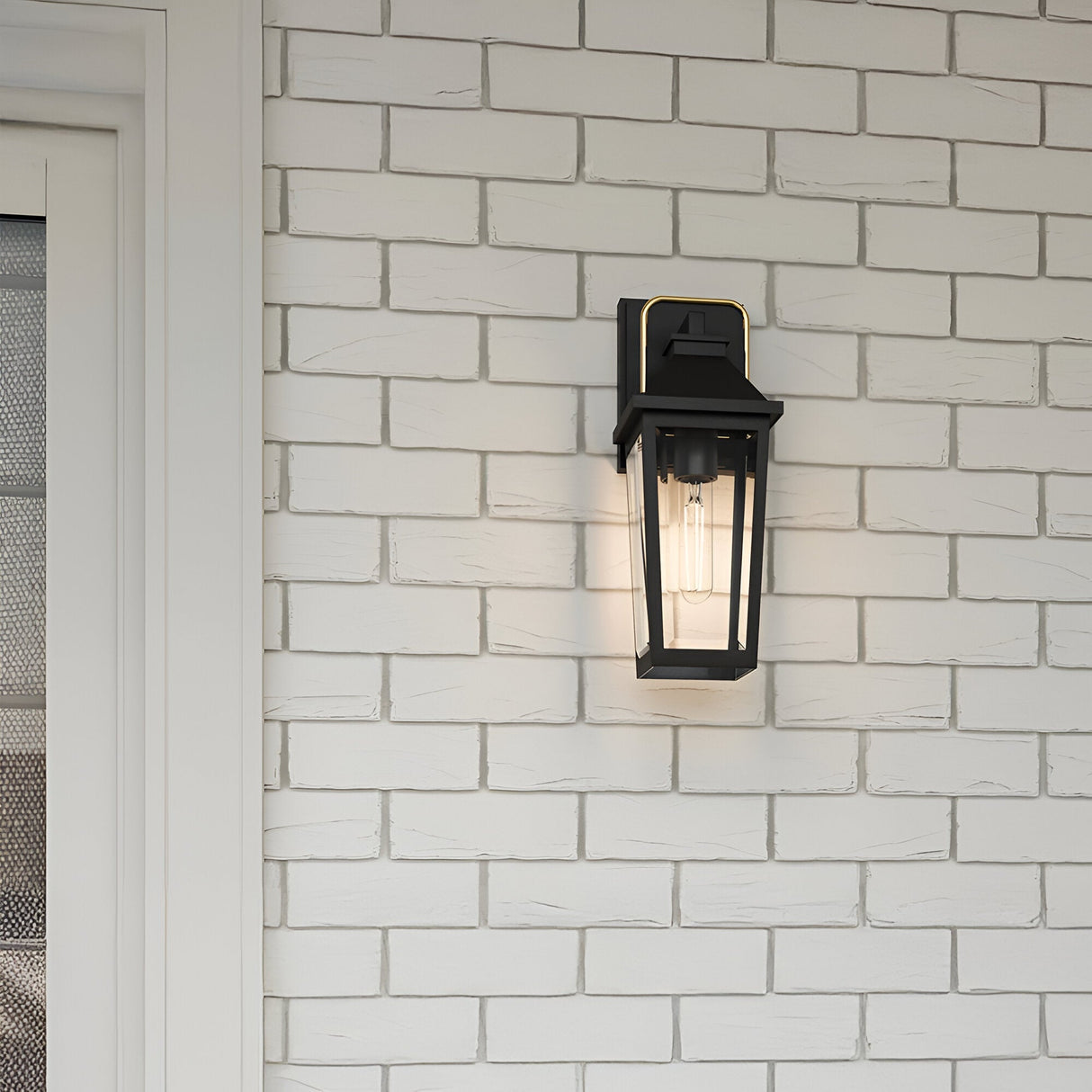 The Buckley 1 Light Coastal Small Outdoor Wall Lights Lantern in black is mounted on a white brick wall beside a screened door, bringing stylish coastal lighting to your entryway.