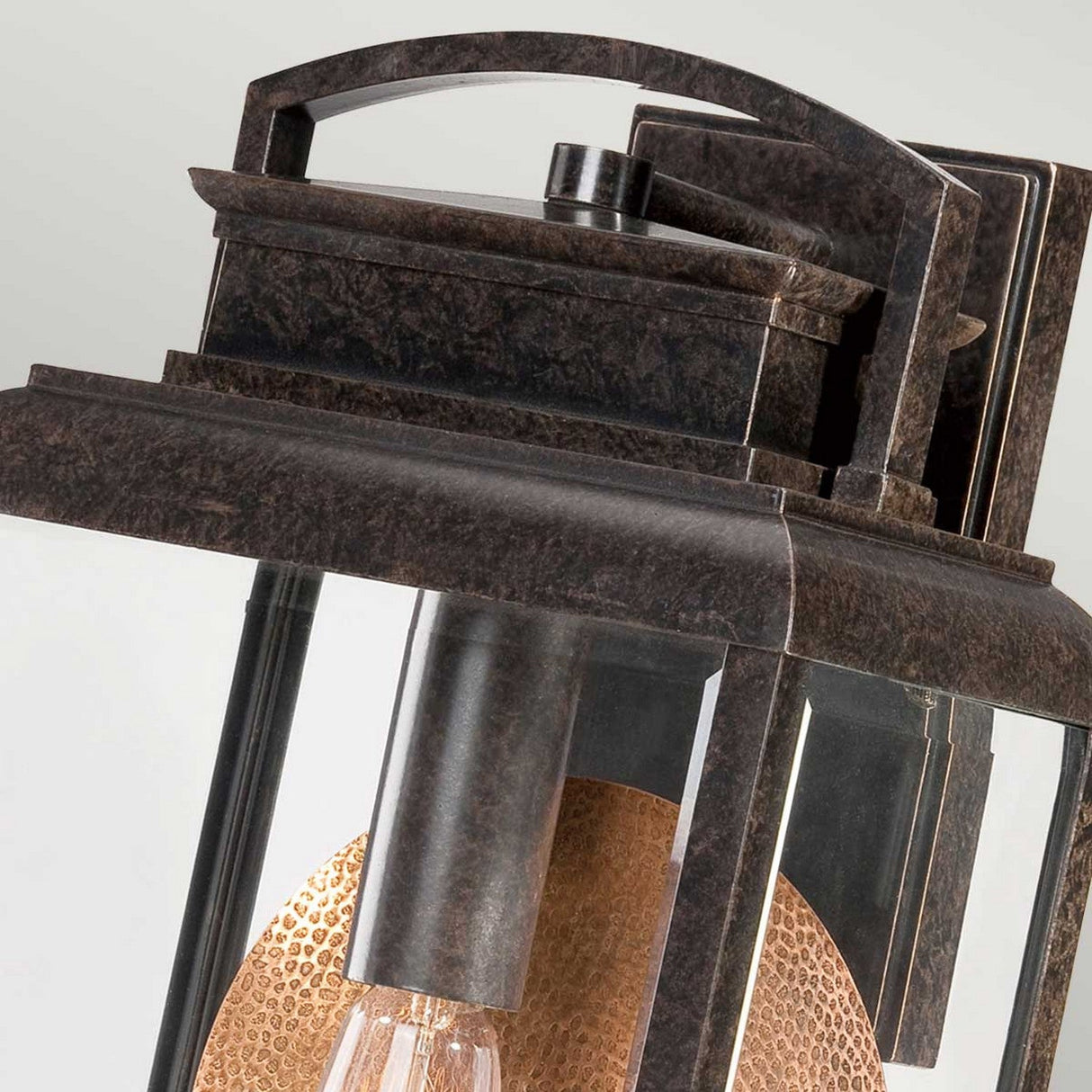 Featuring a close-up of the Byron Outdoor 1 Light Large Wall Lantern in an Imperial Bronze finish with a copper reflector, this vintage-style fixture showcases a rectangular frame with clear glass panels and a warmly glowing bulb inside, set against a plain background.