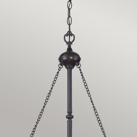 The Vintage Bronze Cambridge 3 Light Pendant Chandelier hangs elegantly from a chain against a light gray backdrop. With its Tiffany-style fixture and decorative center rod, three chains gracefully extend to the sides of its circular base, enhancing its timeless appeal.