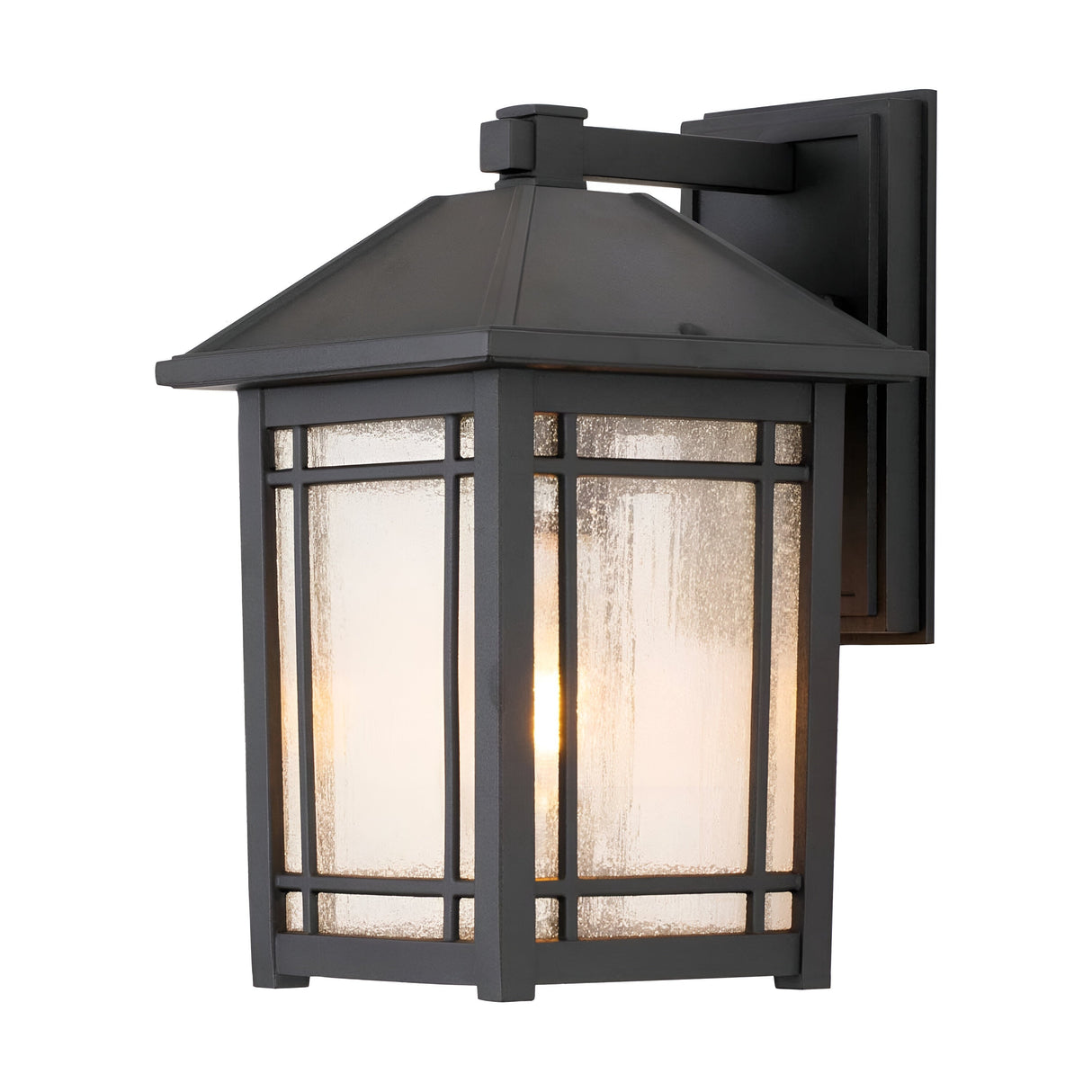 The Cedar Point Outdoor 1 Light Medium Wall Lantern - Black is a black metal fixture designed for outdoor use, featuring a rectangular frame with seedy glass panels. Its minimalist lines and single bulb create a blend of modern and classic aesthetics.