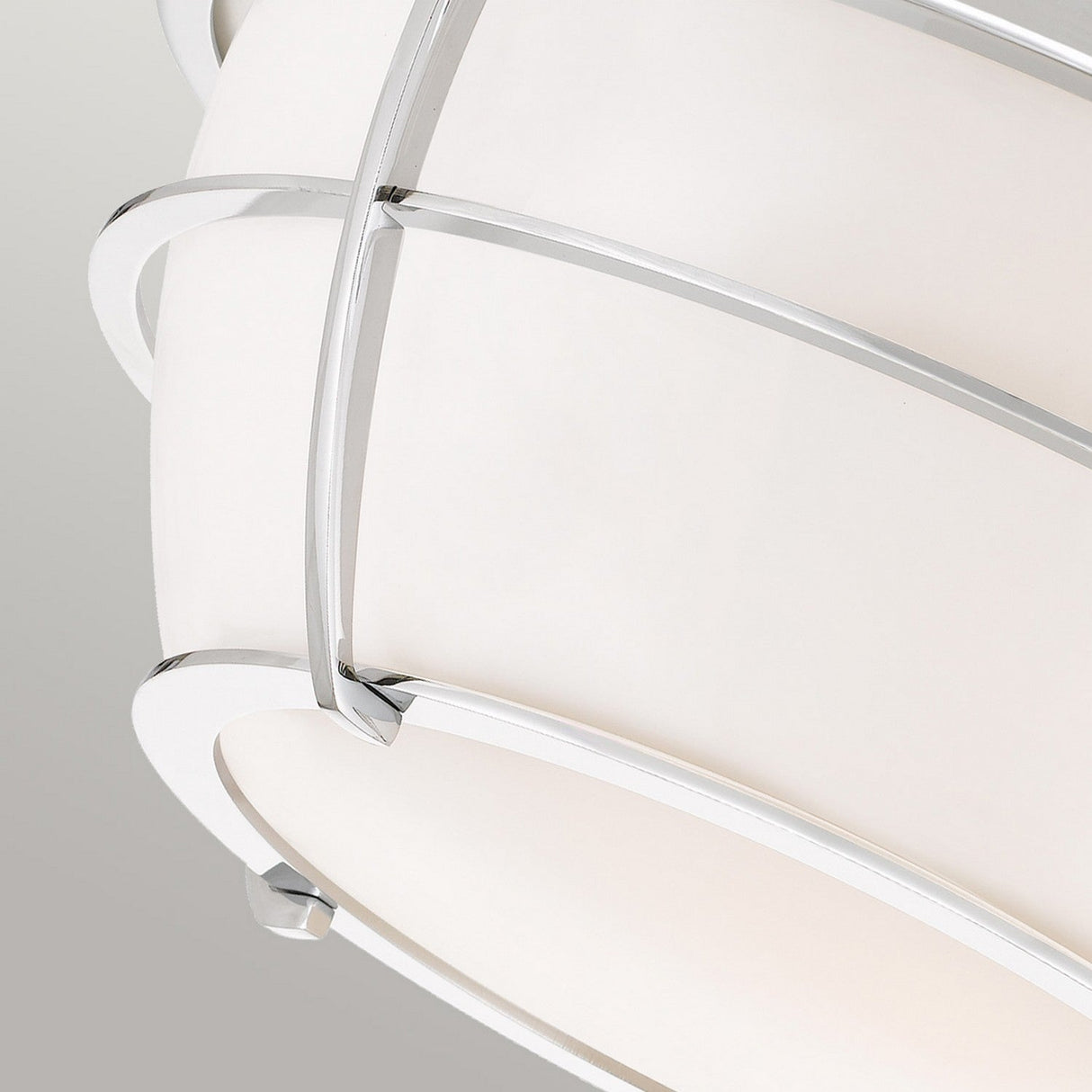 A detailed close-up of the Chance 2 Light Flush features a sleek, curved metal frame complemented by a frosted glass shade. The polished chrome finish accentuates its contemporary elegance, while the IP44 rating makes it suitable for damp environments.