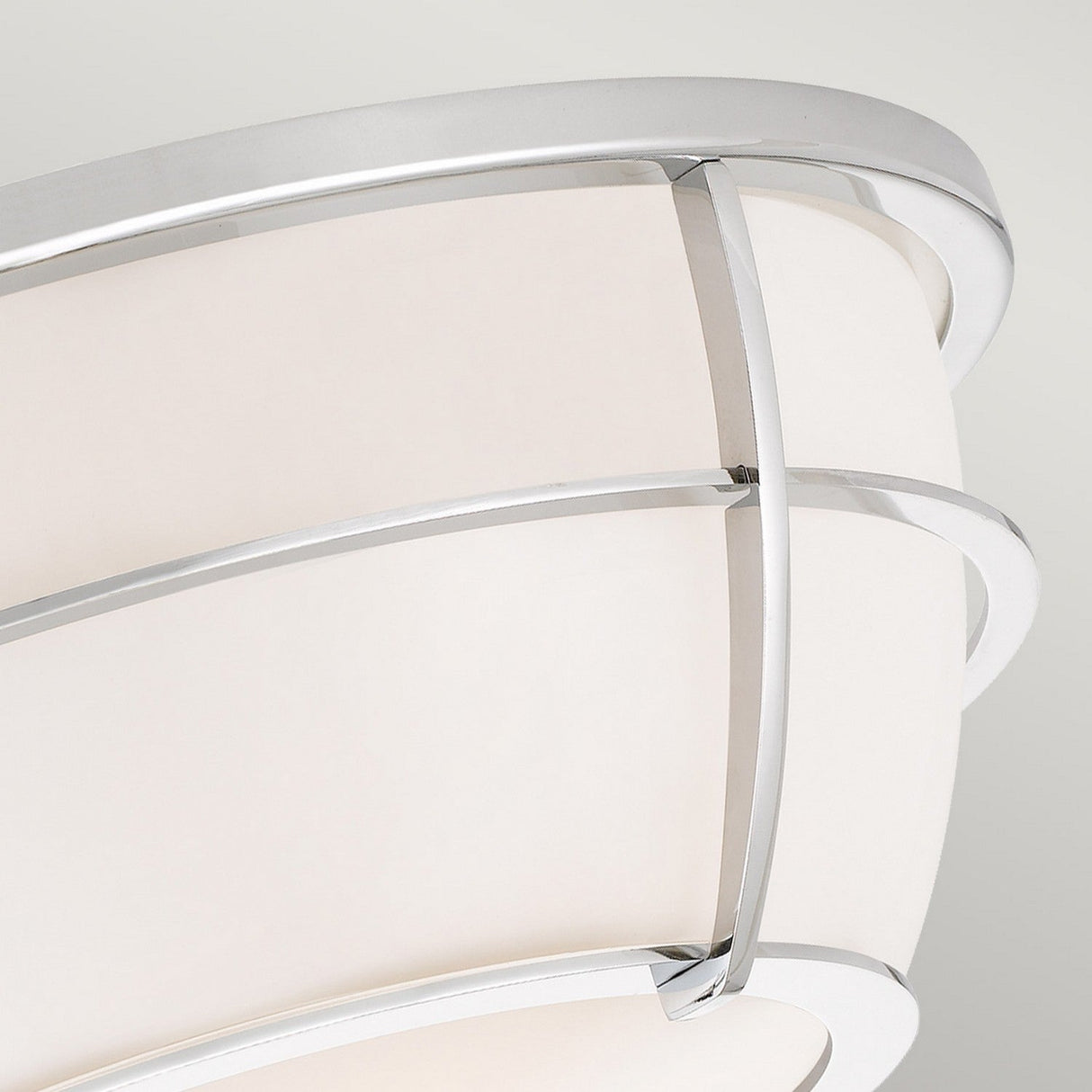 Close-up of the Chance 2 Light Flush in polished chrome, showcasing its modern ceiling light fixture with a curved design. It features smooth, polished chrome bands and a frosted white glass shade, offering a sleek and contemporary look ideal for flush mount lighting in spaces needing an IP44 rating.