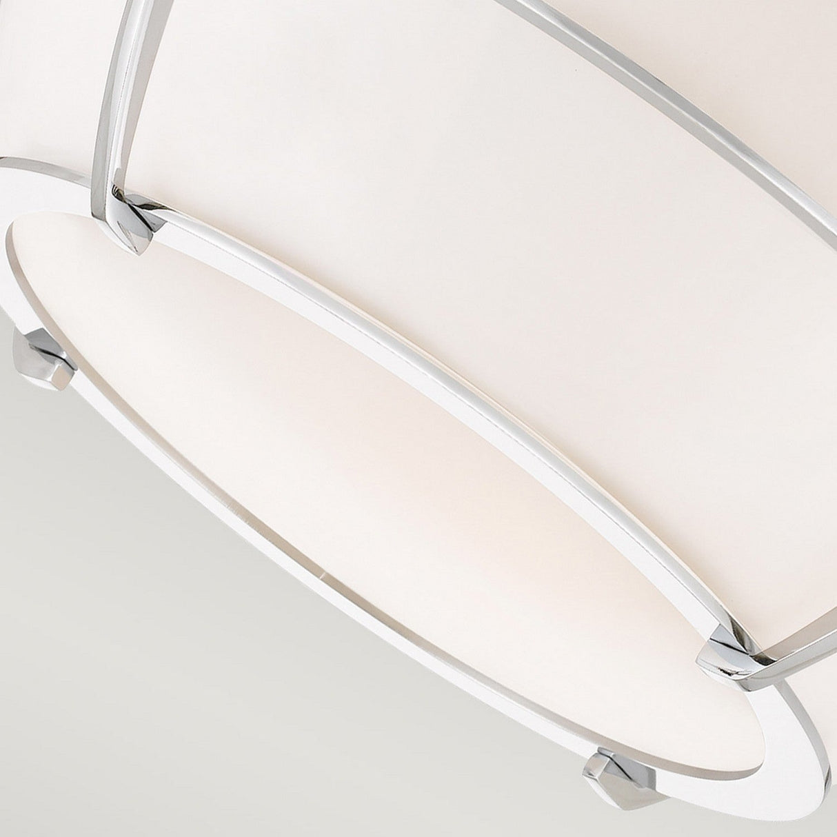 A close-up of the Chance 2 Light Flush, a modern white ceiling light fixture with a circular, minimalist design and polished chrome accents. The flush mount lighting is photographed from below, showcasing its sleek and contemporary style against a neutral background.