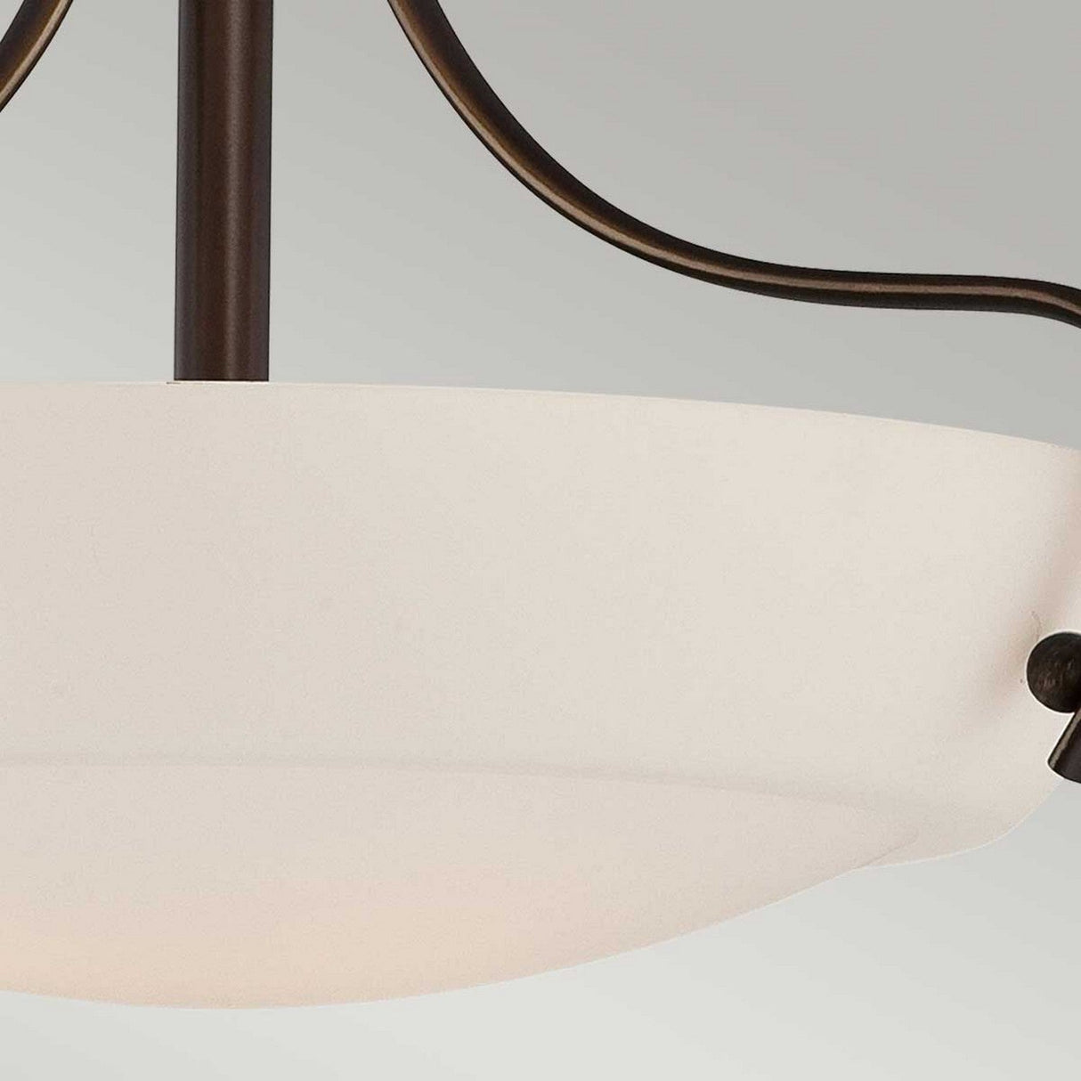 Close-up of the Chantilly 3 Light Semi-Flush ceiling light fixture, showcasing its opal-etched glass diffuser in a frosted bowl shape, encased in a Palladian Bronze finish frame. The image captures the fixture from underneath, emphasizing its simple and elegant design.