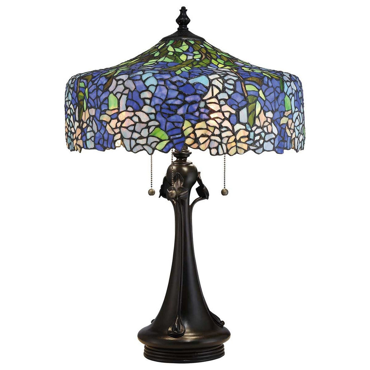 The Cobalt 3 Light Tiffany Table Lamp in Vintage Bronze features a stained glass shade with a mosaic of blue, green, and white floral patterns, reminiscent of hydrangeas. Its ornate dark-colored base is beautifully complemented by two pull chains that hang elegantly below the shade.