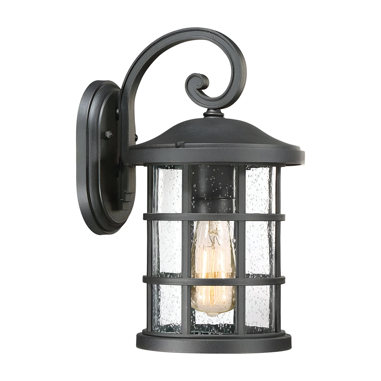 The Crusade Outdoor 1 Light Medium Wall Lantern - Black exudes a rustic charm with its vintage-style design. Its black metal finish and clear seeded glass enclose a single bulb inside a cylindrical cage, mounted on the wall with a decorative curved arm, making it perfect for any IP44 rated space.