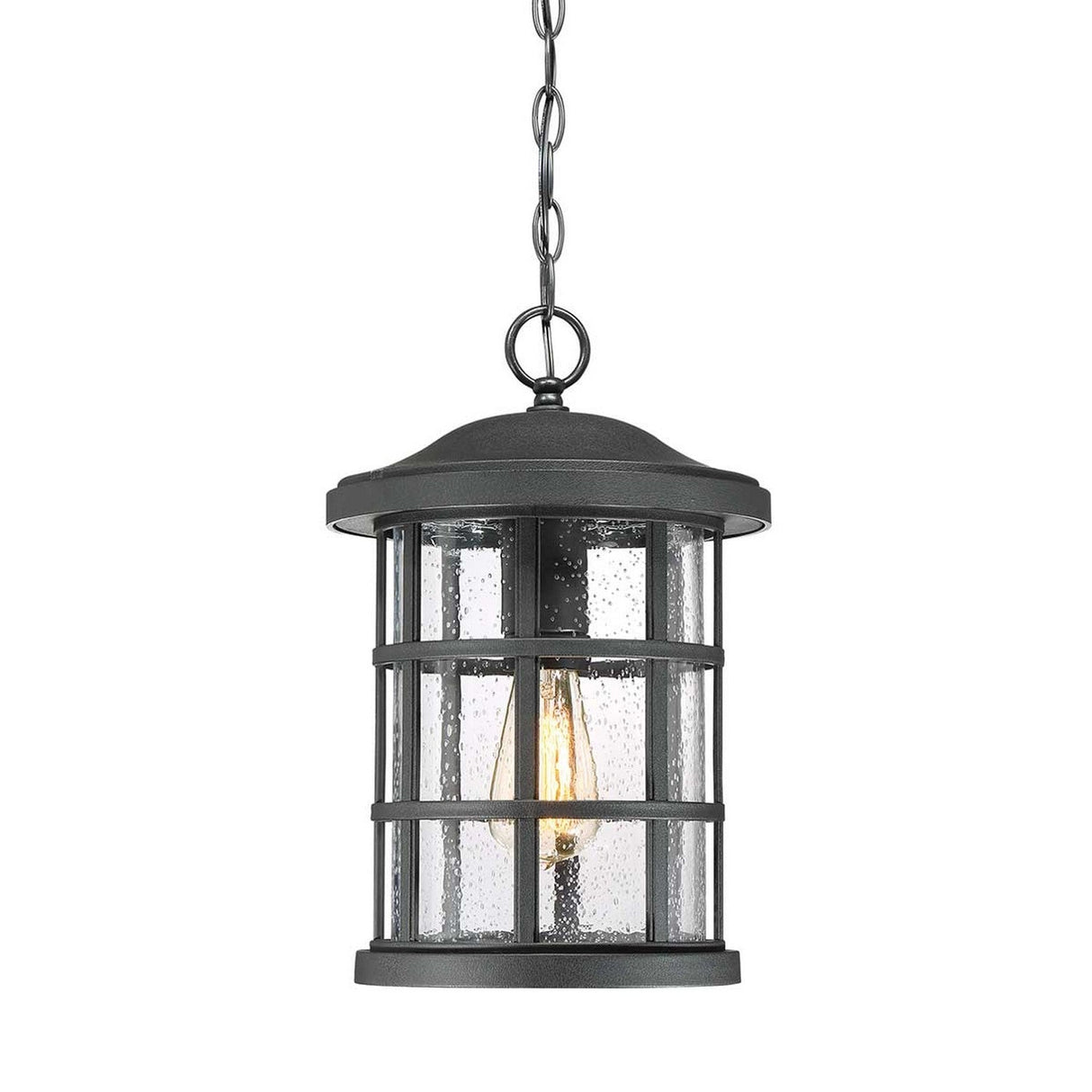The "Crusade Outdoor 1 Light Chain Pendant - Black" features a sturdy metal frame and glass panels. It encloses a single bulb with a decorative filament, showcasing textured glass that resembles rain droplets for a rustic and classic charm.