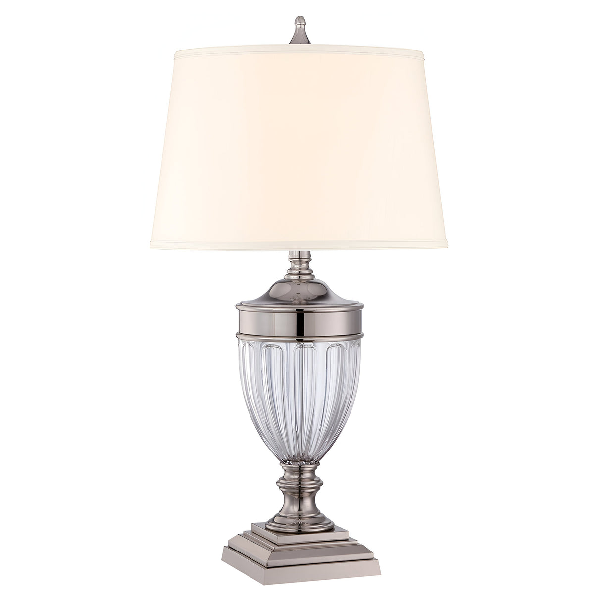 Introducing the Dennison 1 Light Table Lamp - Polished Nickel: a polished silver masterpiece featuring a fluted glass base and a cream-colored lampshade. Resting on a tiered metal pedestal, its polished nickel finish enhances the ambient glow, adding an elegant touch to any decor.