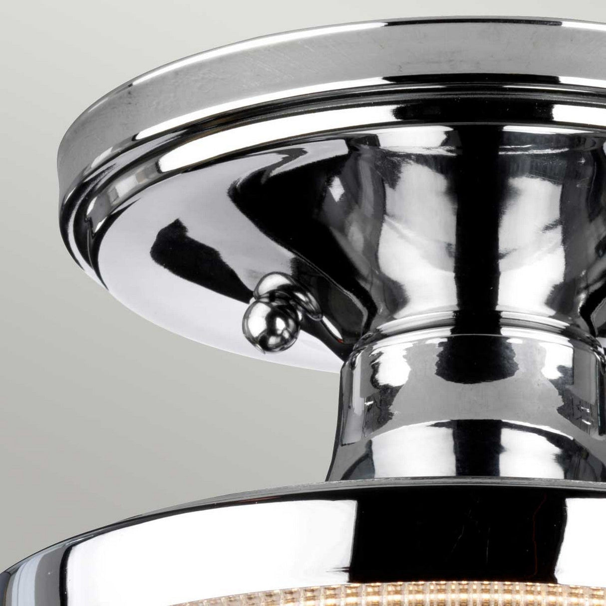 The Dublin 1 Light Semi Flush in polished chrome features a modern and contemporary design with a sleek, glossy finish. Its reflective metallic surface stands out beautifully against a neutral background, making it the ideal choice for bathroom lighting.