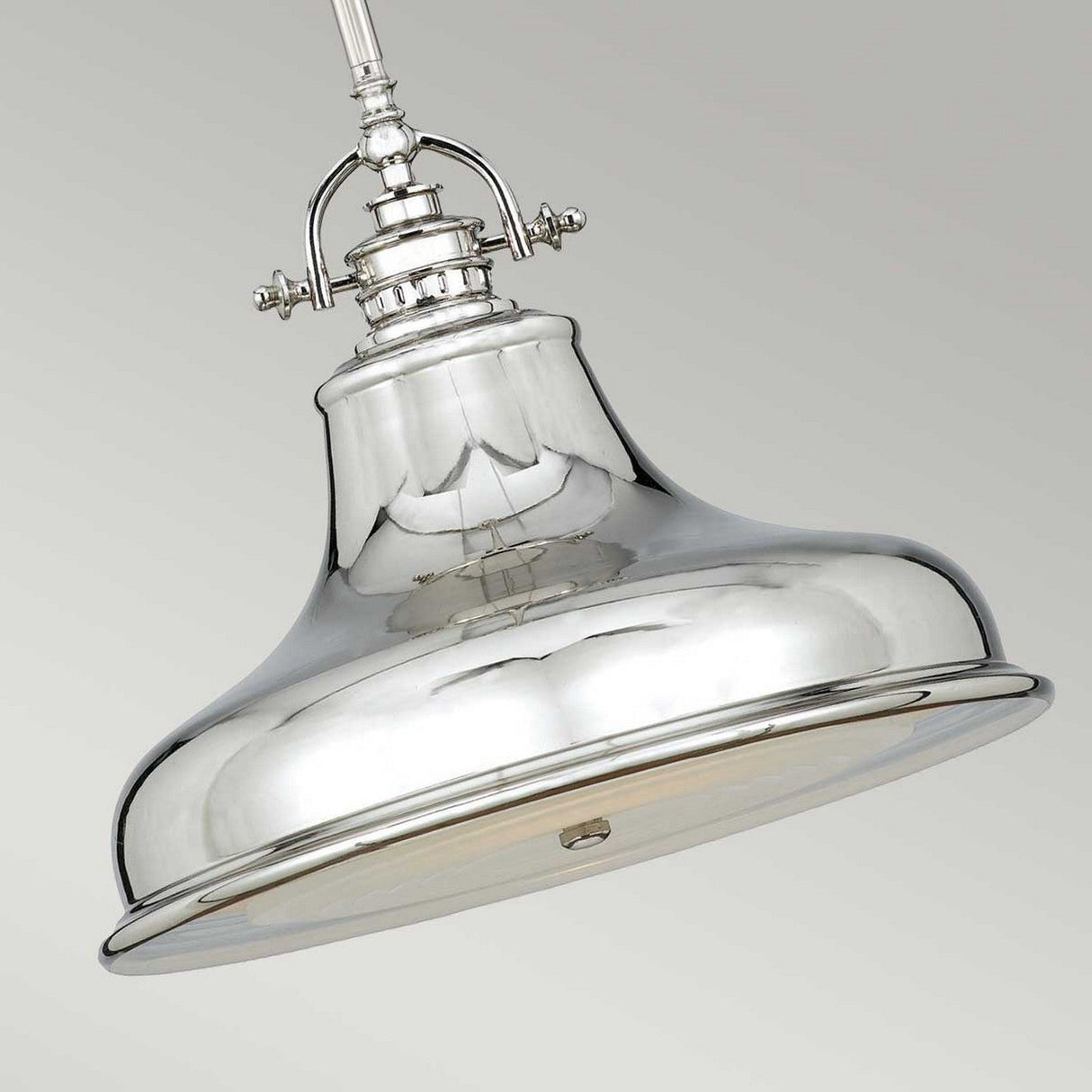 The Emery 1 Light Medium Pendant - Imperial Silver is a gleaming, dome-shaped metal fixture that boasts a polished finish, perfect for reflecting its surroundings. Suspended gracefully from a rod, it includes bolt-like decorative accents at the top, infusing any space with a hint of industrial charm.