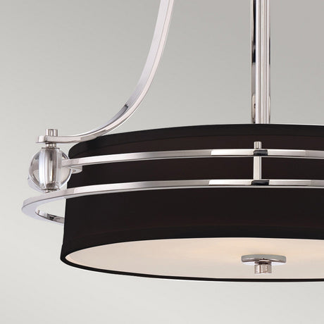 A close-up of the Gotham 4 Light Small Chandelier in Imperial Silver, showcasing its modern circular design with a black and silver finish. This ceiling light fixture features sleek metal accents and a translucent glass cover, all set against a light gray background.