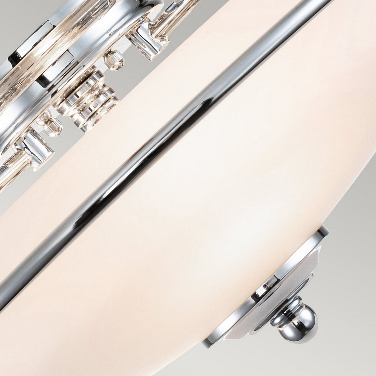 Close-up of the Griffin 3 Light Flush in polished chrome, featuring modern chrome and white elements. The circular design highlights smooth finishes and intricate metalwork, offering a polished chrome finish for an elegant and contemporary touch to any lighting decor.