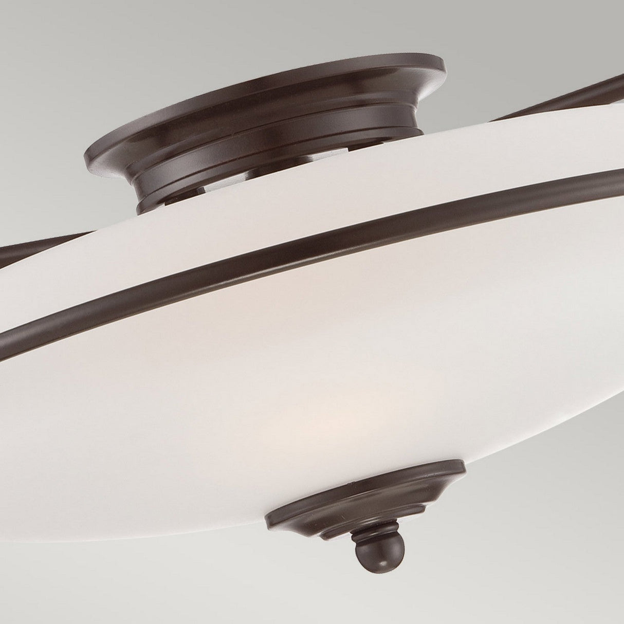 Close-up of the Griffin 3 Light Flush - Palladian Bronze ceiling fixture, showcasing its etched glass shade with Palladian Bronze accents, set against a light gray background.