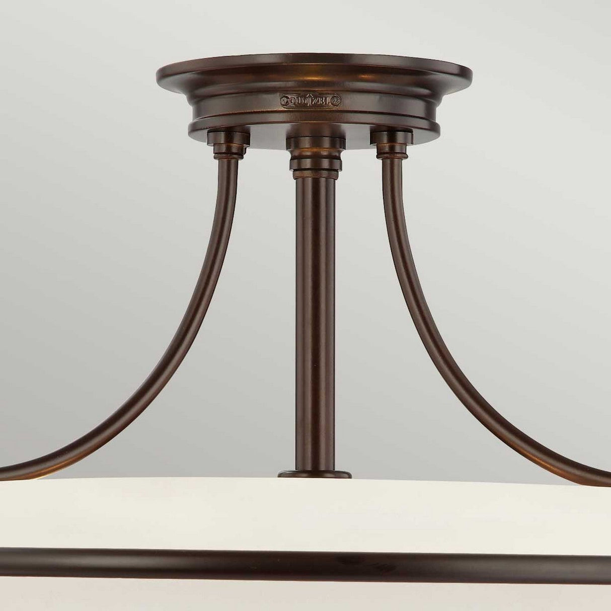 The Griffin 4 Light Semi-Flush in Palladian Bronze showcases a close-up view, highlighting its three curved supports linking the ceiling mount to an etched glass shade. This modern and elegant design is ideal for contemporary interiors.