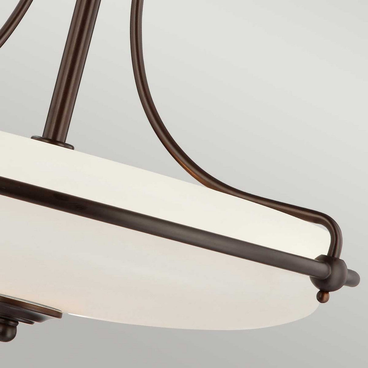 Close-up view of the Griffin 4 Light Semi-Flush in Palladian Bronze, featuring a modern circular ceiling light design with an etched glass shade and dark metal frame. The fixture's support rods extend to the frame, providing a sleek and contemporary aesthetic.