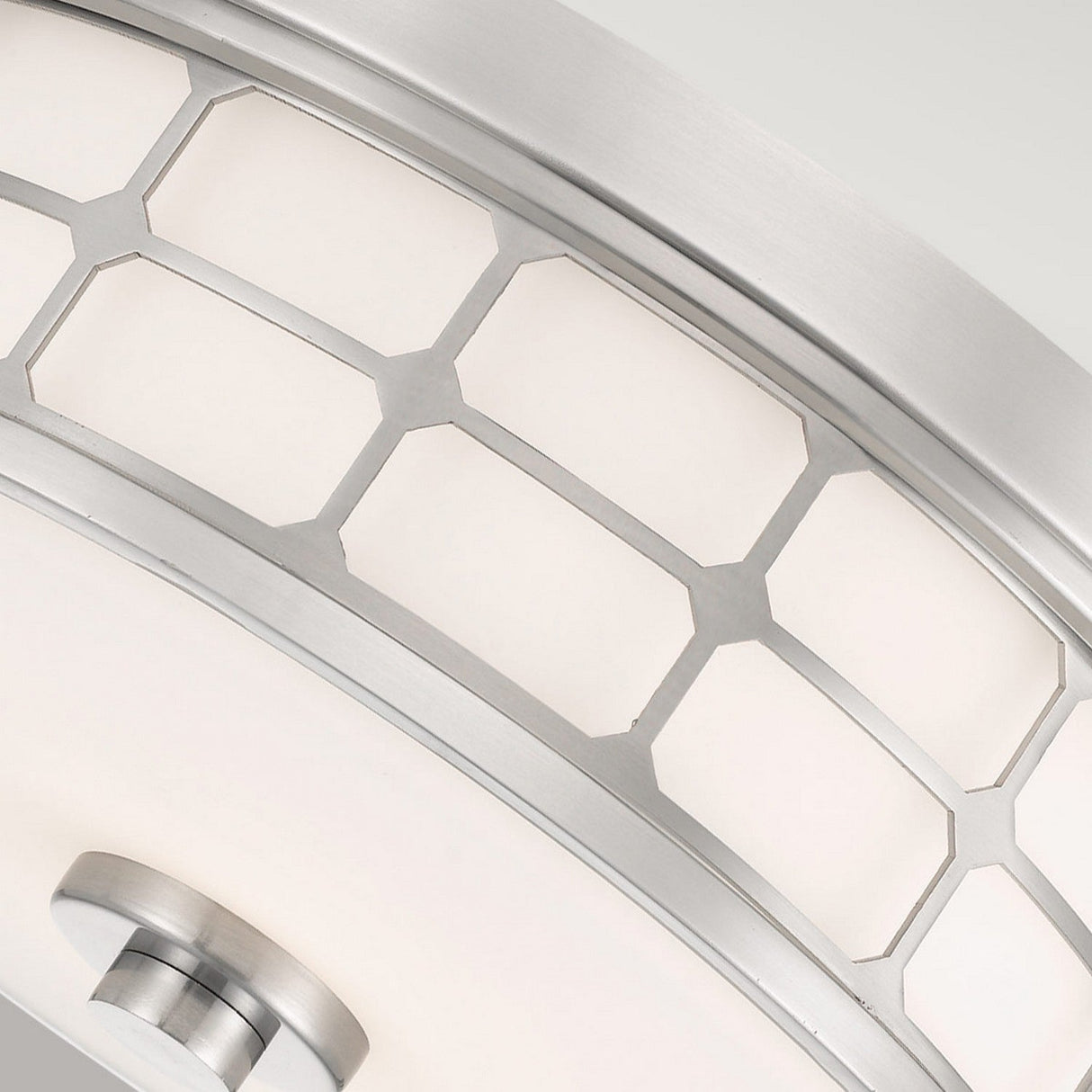Close-up of the Guardian 2 Light Flush featuring a modern geometric design. It showcases hexagonal metal frames and an opal glass shade in brushed nickel, all in a sleek flush mount design against a light gray background.