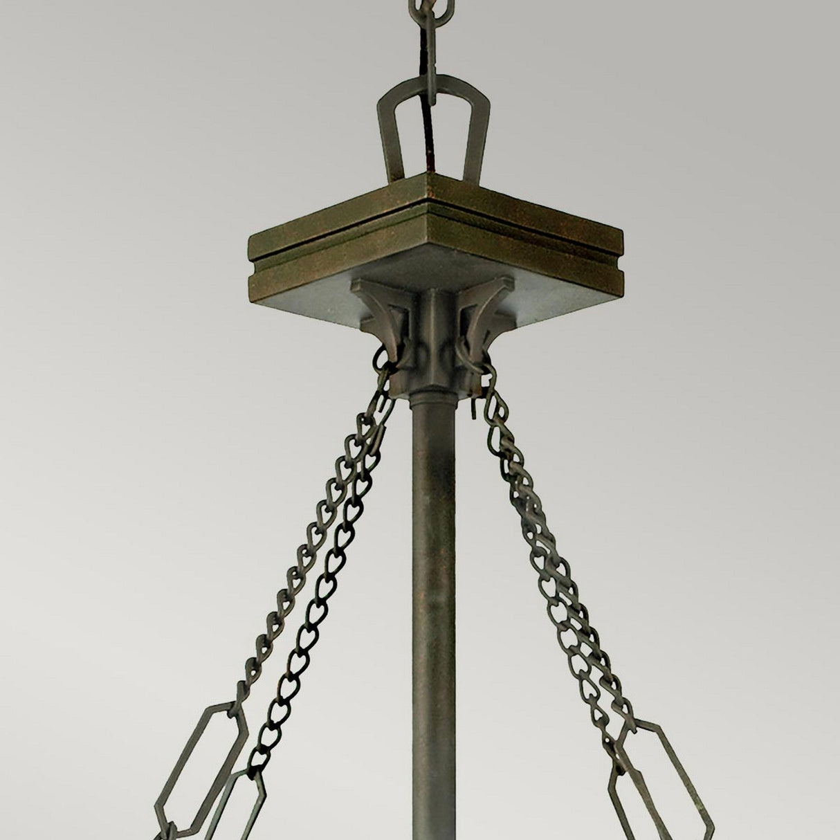 The Inglenook 3 Light Large Tiffany Pendant showcases an industrial design, featuring a square base with a central rod and multiple chains hanging downward. It is adorned in a valiant bronze finish set against a light gray background.