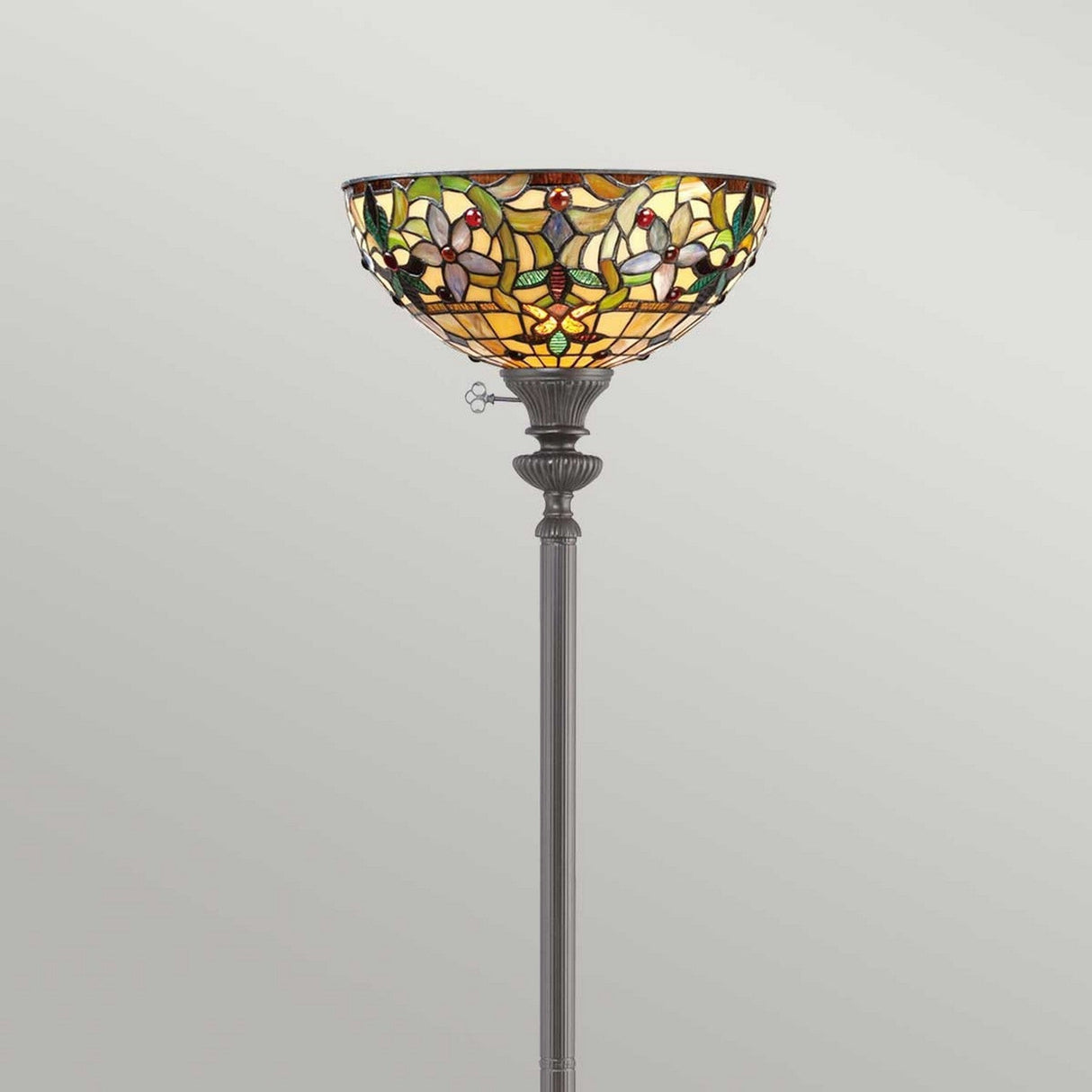 Showcasing a vibrant, handcrafted stained glass lampshade with floral patterns, the Kami 1 Light Tiffany Torchiere features a tall floor lamp design. Its base has a classic style in vintage bronze that brings timeless elegance to any room.