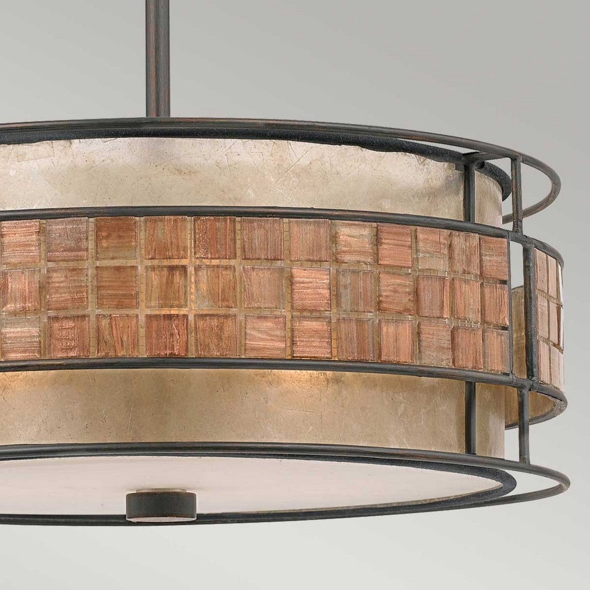 Introducing the Laguna 4 Light Chandelier in Renaissance Copper, a striking blend of cylindrical design and grid pattern with copper-colored squares. Its metallic frame, enhanced by circular bands enclosing frosted glass, creates an elegant contrast against a plain backdrop.