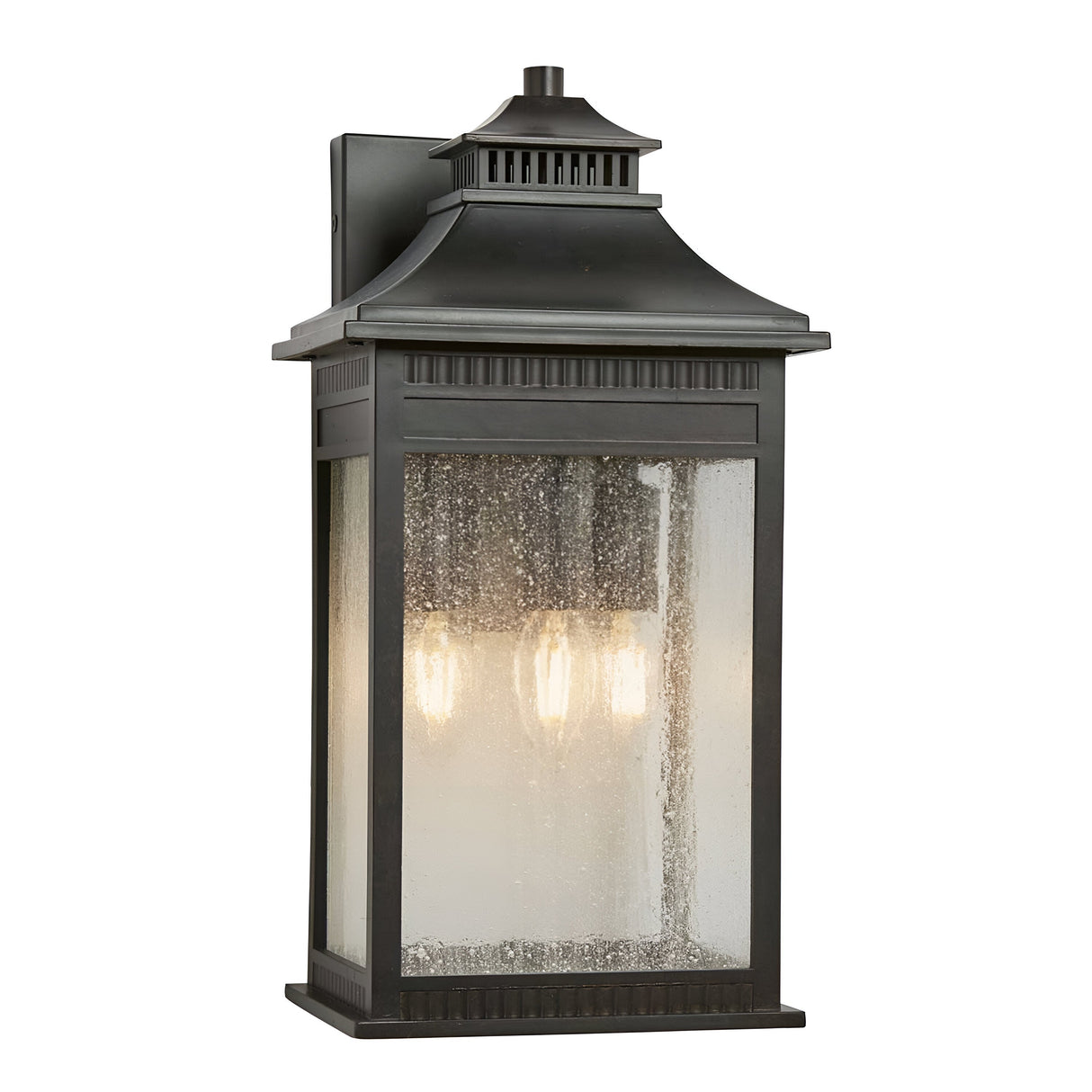 The Livingston Outdoor 3 Light Large Wall Lantern in Imperial Bronze showcases a rectangular shape with seedy glass panels. Inside, three light bulbs create a warm glow, enhanced by a decorative top design for an elegant touch.