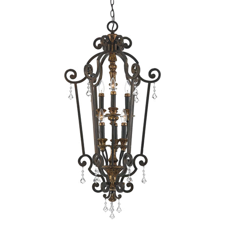 The Marquette-B 6 Light Chandelier in bronze showcases an ornate design with elegant scrollwork and crystal drops. This vintage-style fixture features a wrought iron construction and multiple candle-style lights at its center.