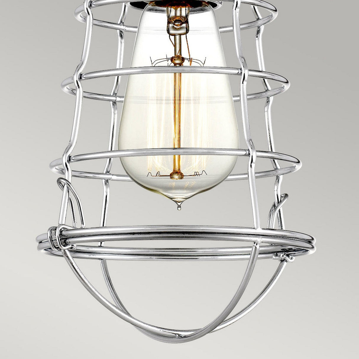 A Mixon 1 Light Semi-Flush fixture in polished chrome features a vintage-style bulb encased in a sleek wire cage, suspended against a neutral background. The exposed filament enhances the retro aesthetic with an industrial design touch.