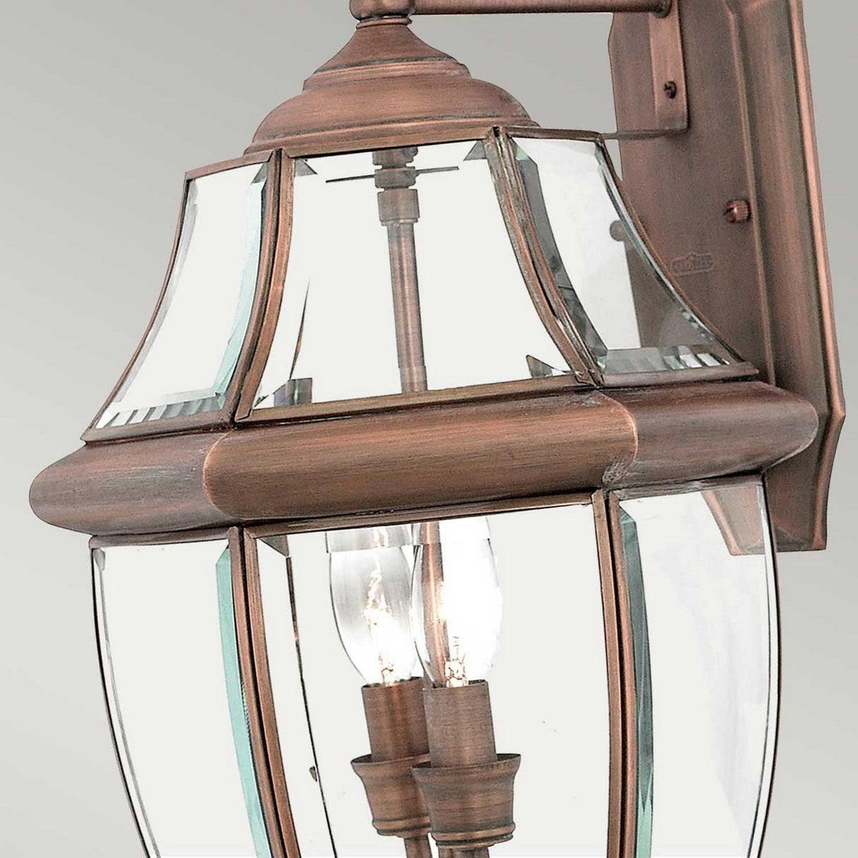 Newbury Outdoor 2 Light Large Wall Lantern in Lacquered Aged Copper, featuring a traditional design with clear beveled glass panels and two visible light bulbs.