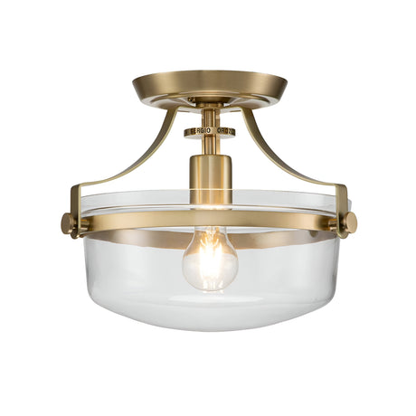 Introducing the Penn Station 1 Light Semi-Flush in Brushed Brass—a sleek lighting fixture featuring an exposed bulb within a clear glass shade. Its industrial design, characterized by clean lines and a contemporary style, makes it an ideal choice for any space.