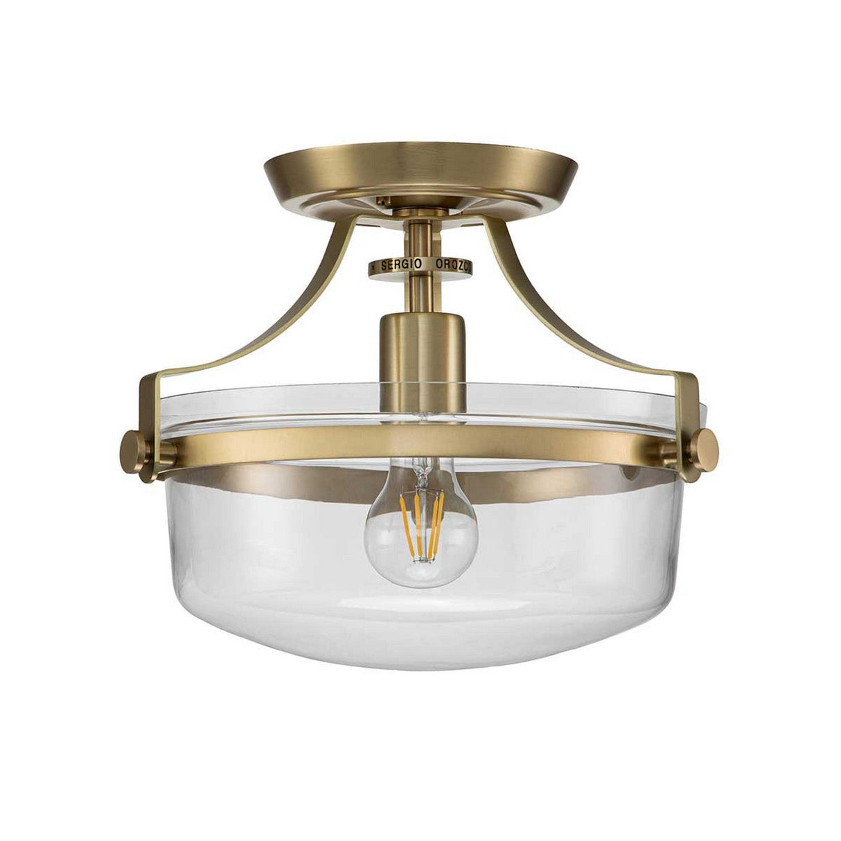 Introducing the Penn Station 1 Light Semi-Flush in Brushed Brass, featuring a clear glass shade and exposed bulb design. This fixture seamlessly combines elegance with an industrial aesthetic, perfect for contemporary interiors.