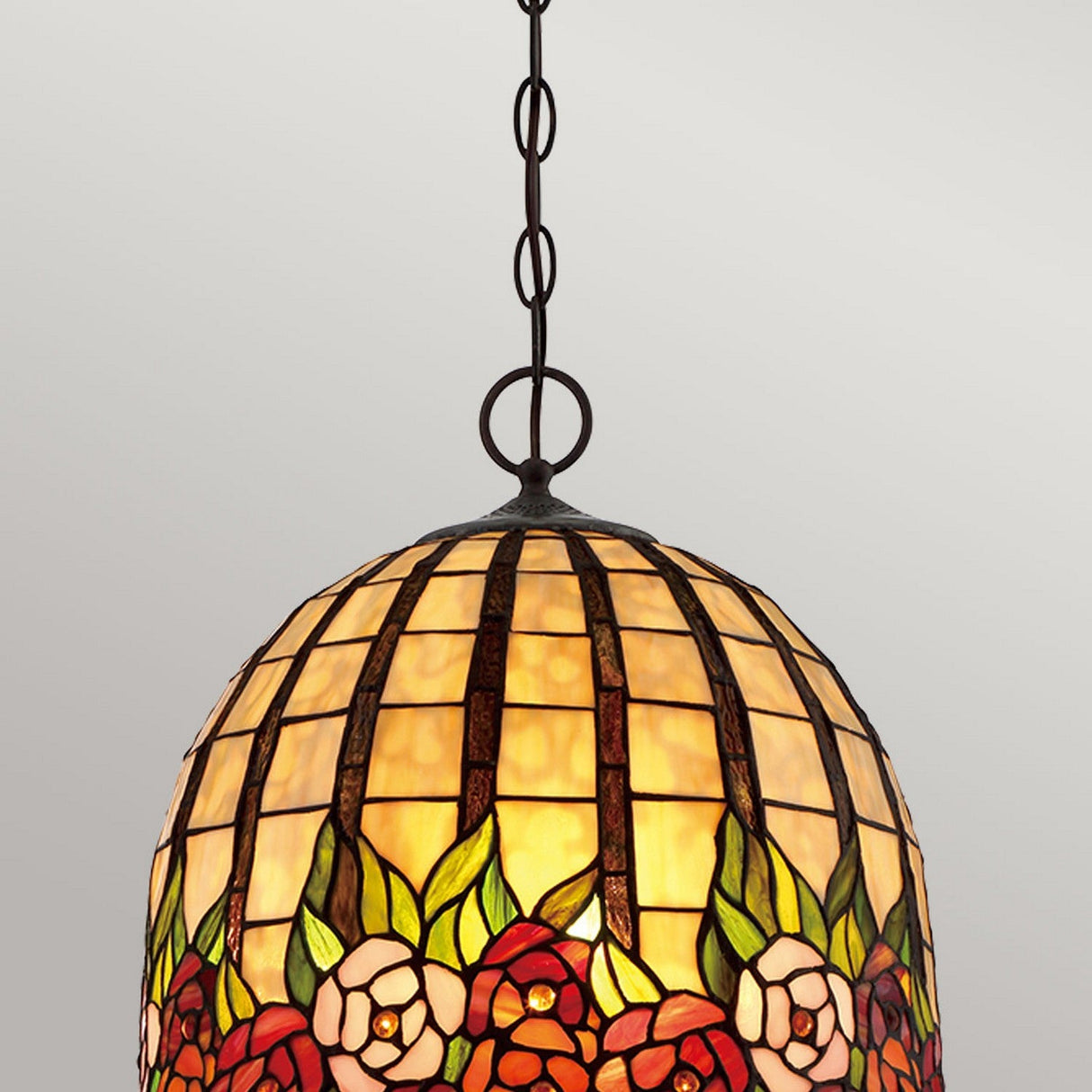 The Rosecliffe 3 Light Tiffany Pendant in Imperial Bronze features a dome-shaped shade with a floral design in shades of red, orange, and green. Highlighted by rose patterns, it hangs elegantly from an imperial bronze chain, beautifully contrasting a neutral background.