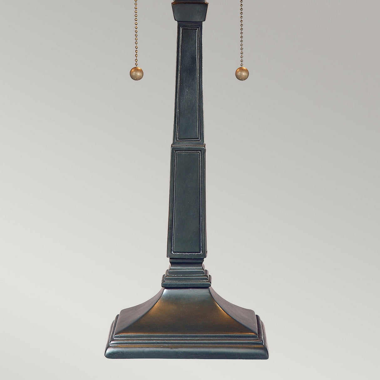 The Stephen 2 Light Tiffany Table Lamp in Vintage Bronze features a tall, square stepped design with two hanging pull chains, evoking the style of Frank Lloyd Wright, set against a plain background.