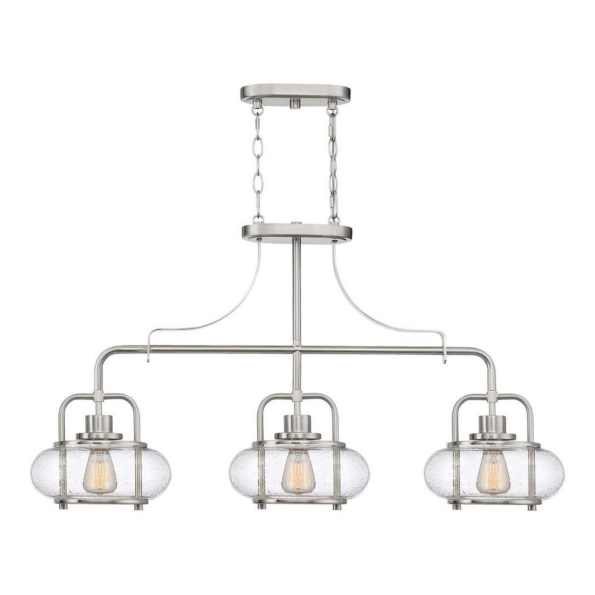 The Trilogy 3 Light Island Light in brushed nickel features a modern design with three lights encased in clear seeded glass oval shades. Each shade houses an exposed filament bulb, and the fixture gracefully suspends from the ceiling mount using two chains.