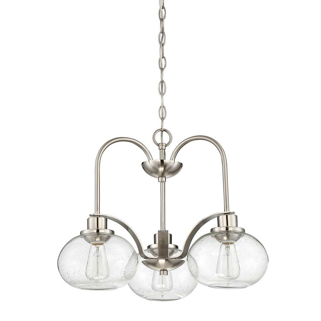 The Trilogy 3 Light Chandelier - Brushed Nickel features a contemporary design with three curved metallic arms, each holding a round seeded glass shade. The semi-flush fixture is suspended by a chain, with each shade encasing a visible light bulb for an elegant and modern look.