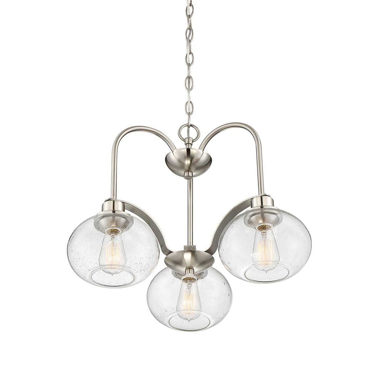The Trilogy 3 Light Chandelier - Brushed Nickel showcases a modern aesthetic with its sleek design, featuring three clear glass globes, each housing a filament bulb and suspended from a brushed nickel metal frame and chain.