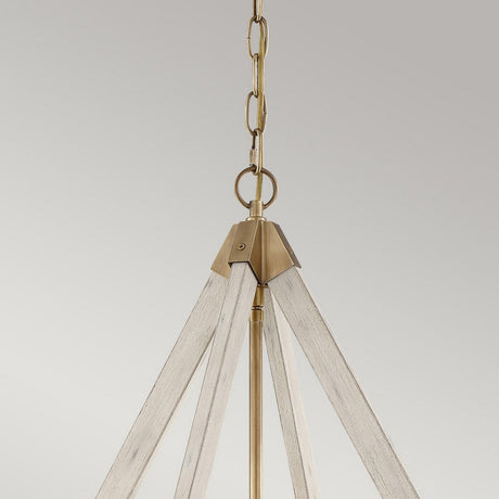 The View Point 3 Light Chandelier, featuring a triangular frame, is suspended from a chain against a neutral backdrop. It showcases a whitewash wood effect that pairs beautifully with the weathered brass accents, enhancing its farmhouse charm.
