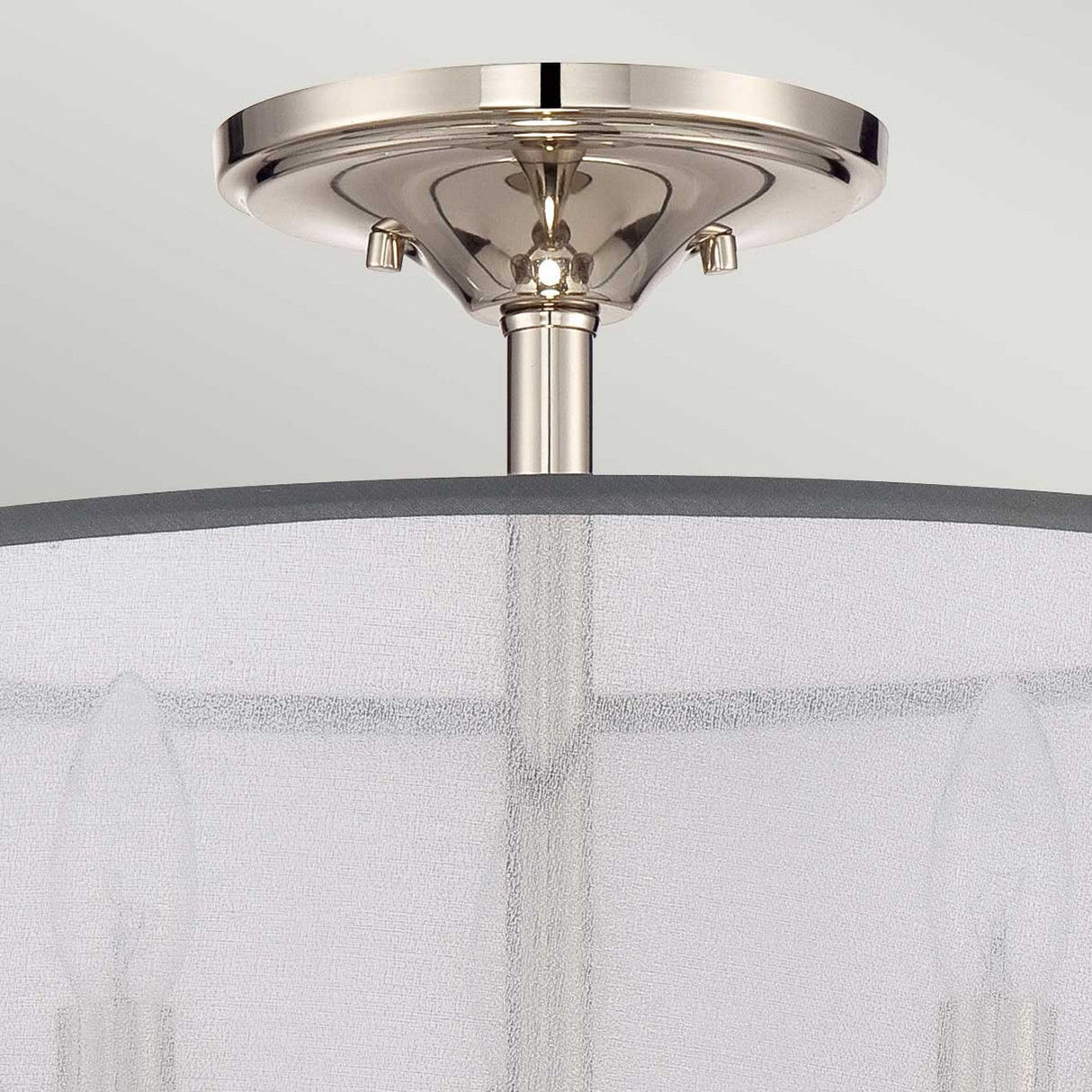 The Whitney 3 Light Semi-Flush - Imperial Silver showcases a contemporary ceiling light fixture, featuring three candle-style bulbs encased within a translucent cylindrical fabric shade for a touch of subtle elegance in your space.