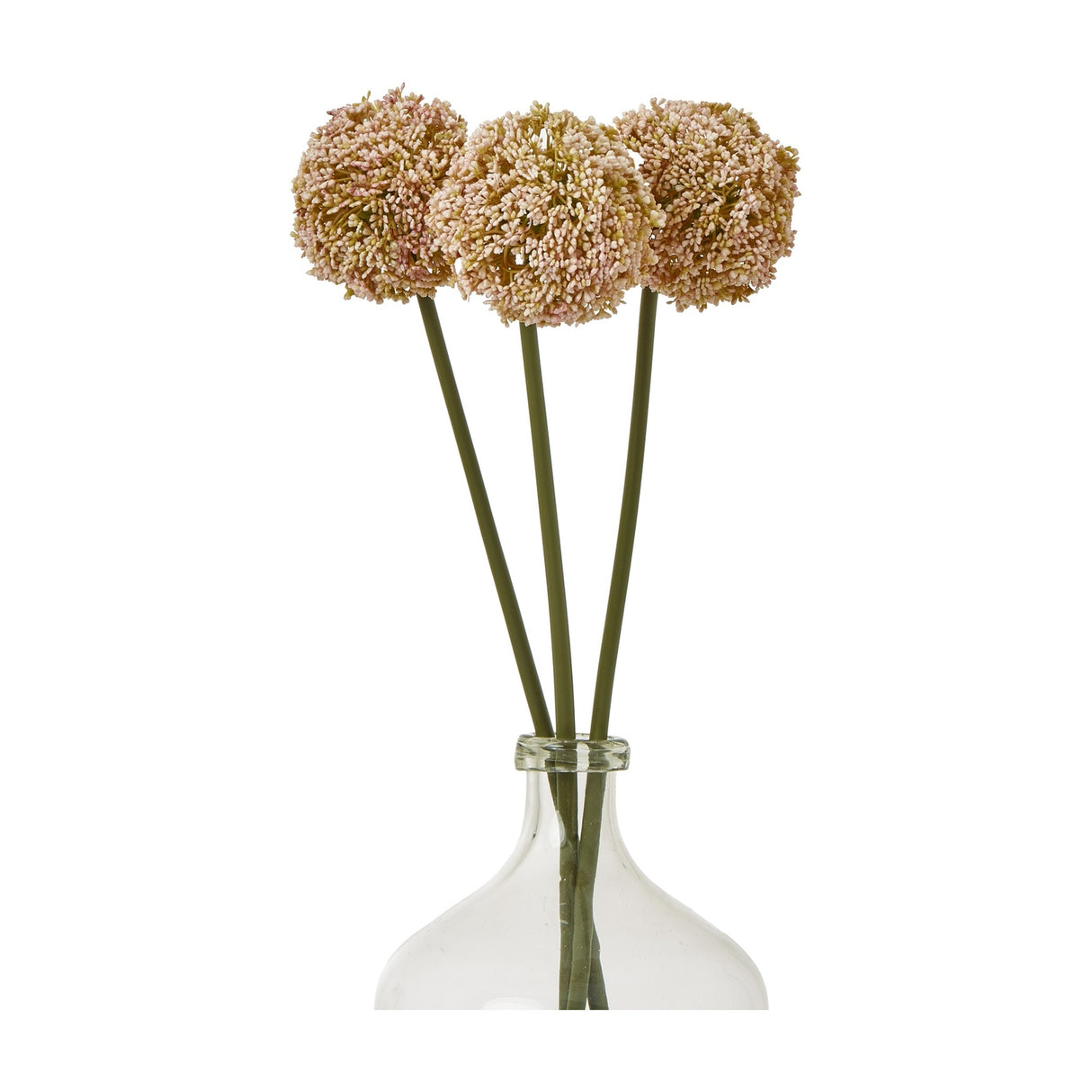 Three Hill Interiors Pink Allium Stem faux flowers with round pom-pom blooms in soft rose tones, arranged in a clear glass bottle vase on a white background.