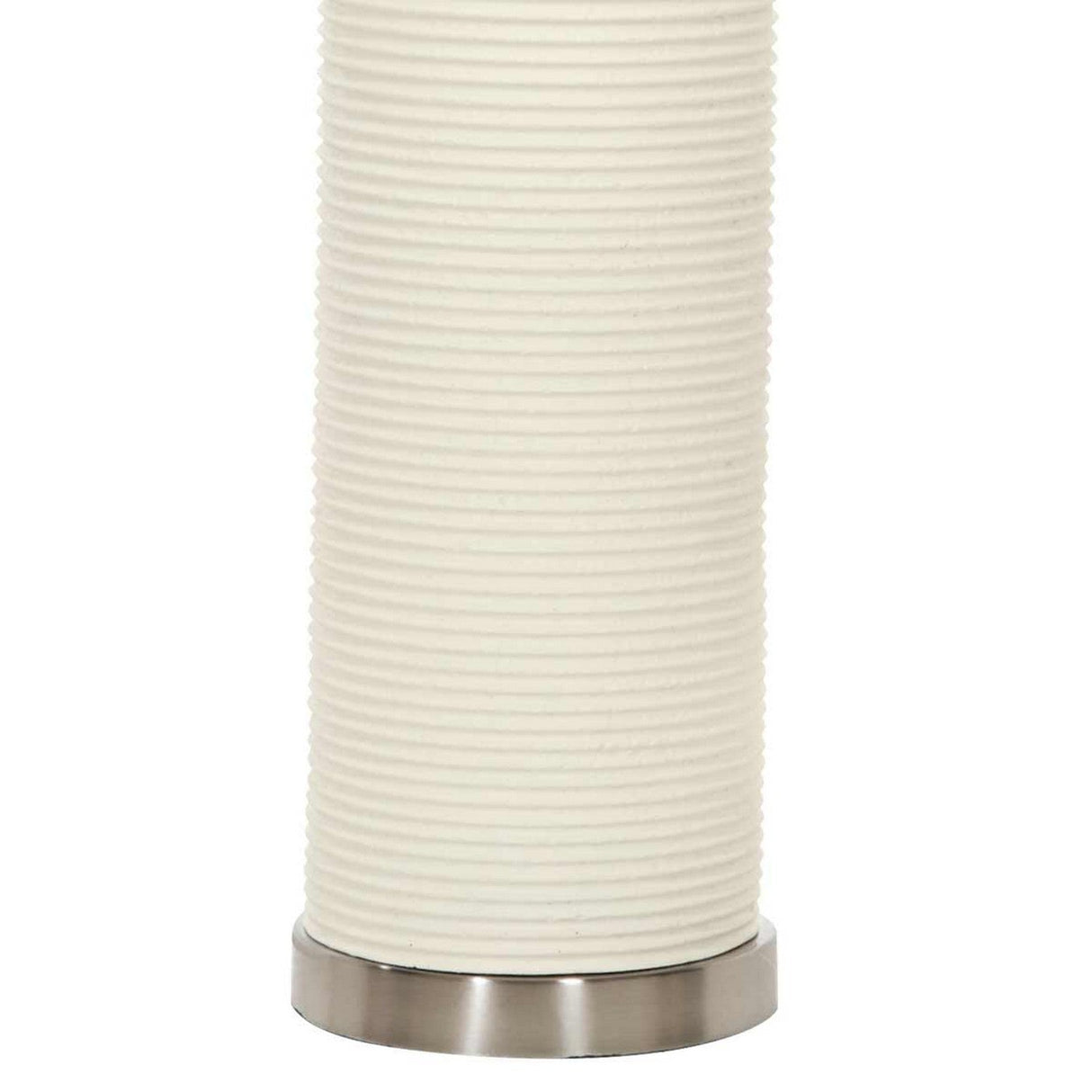 Close-up of the Ripple 1 Light Table Lamp - White With White Shade, showcasing its white cylindrical shade with a ribbed texture and a silver metal base. The neutral colors and straightforward design highlight a modern, minimalist style.