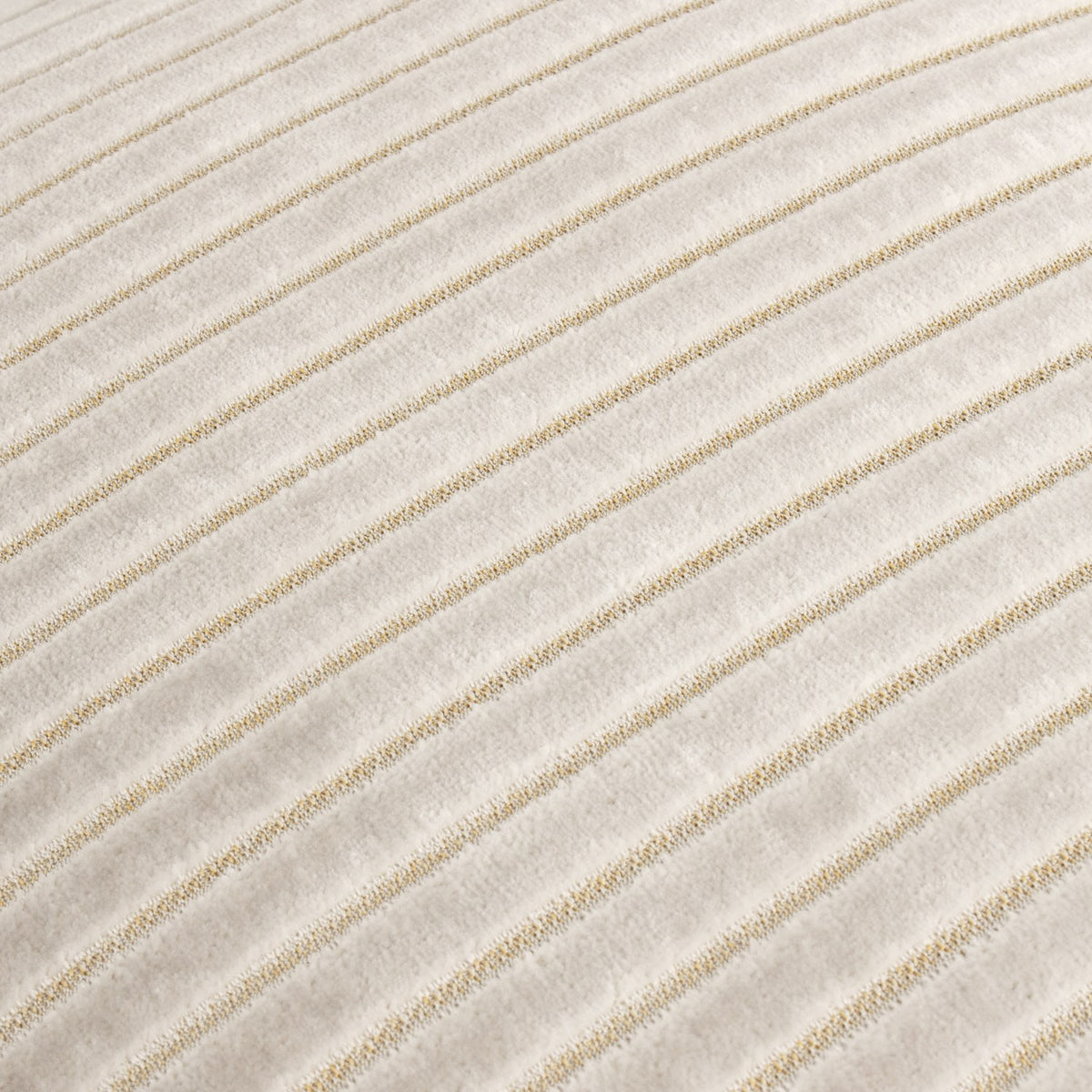 Close-up of the Savoy Stripe cushion in oyster cream, showing raised cut-velvet ribs with a subtle gold shimmer between finer channels.