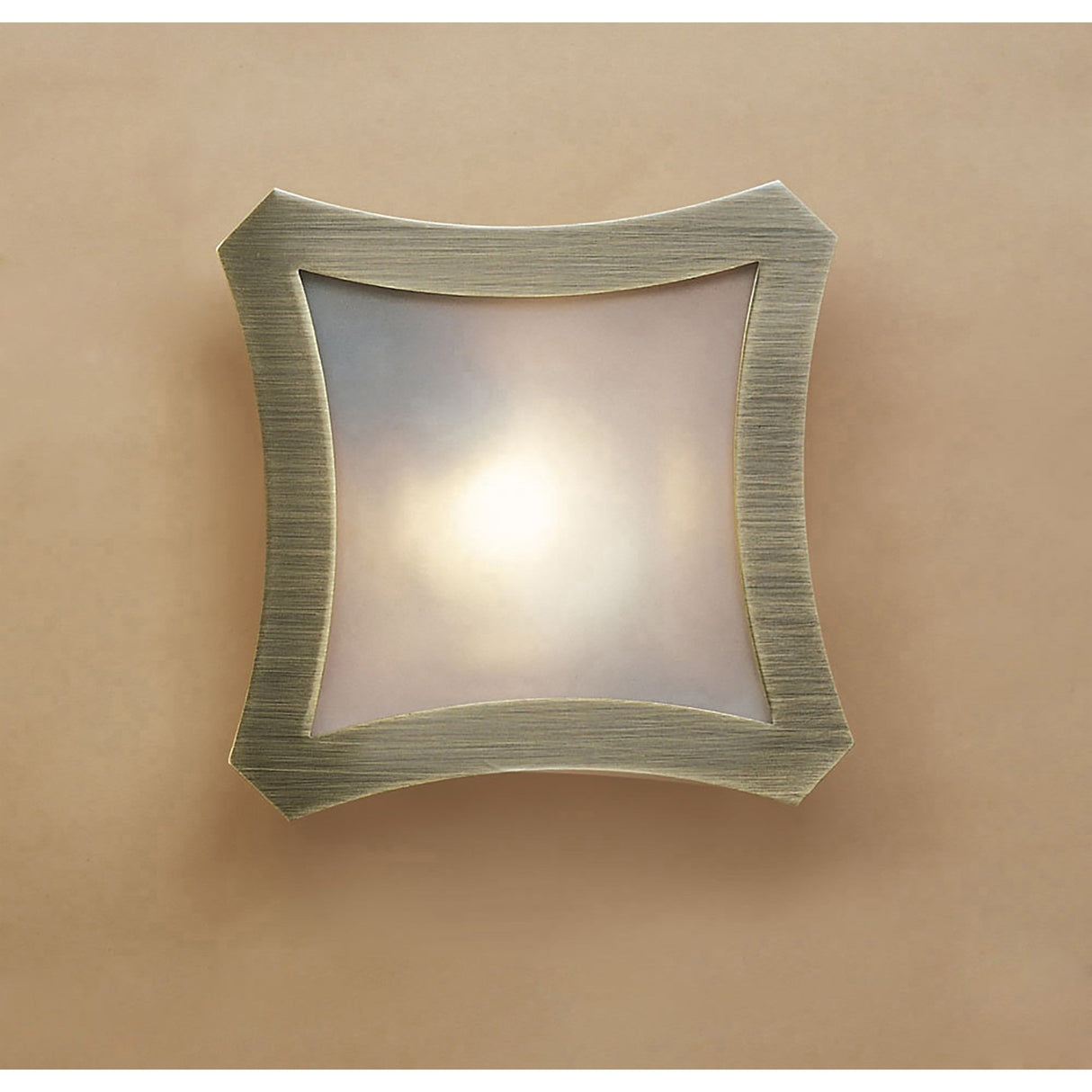 Mantra Rosa Del Desierto flush ceiling light with antique brass four-lobe frame and frosted glass shade, mounted on a warm neutral wall.