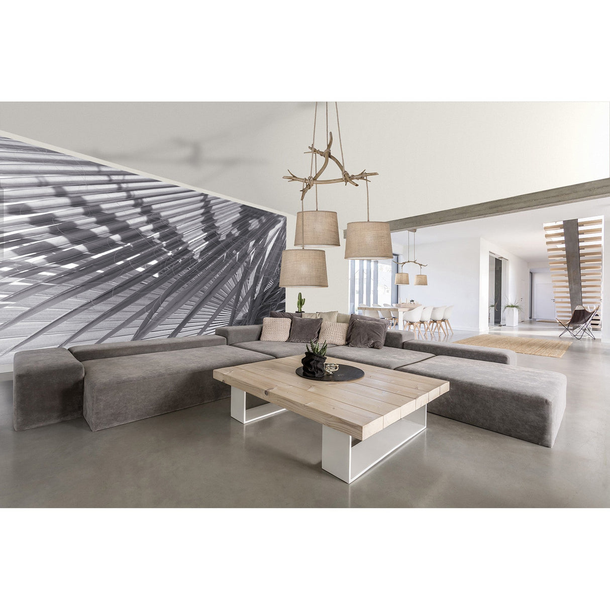Mantra Sabina 3 light cluster pendant with imitation wood branch frame and beige linen drum shades, hung above a grey sofa in an open living space.