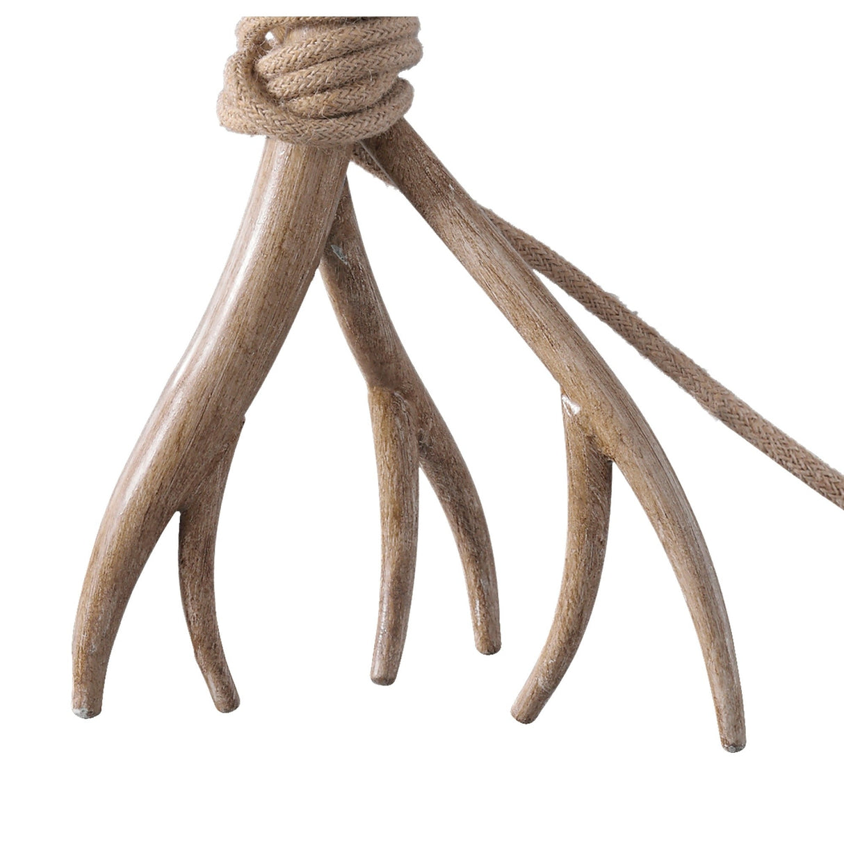 A close-up of the Sabina 1 Light Table Lamp shows a tan rope looped around four-tined light brown antlers, forming a distinctive base. The rustic lamp features a linen shade and is set against a white background.